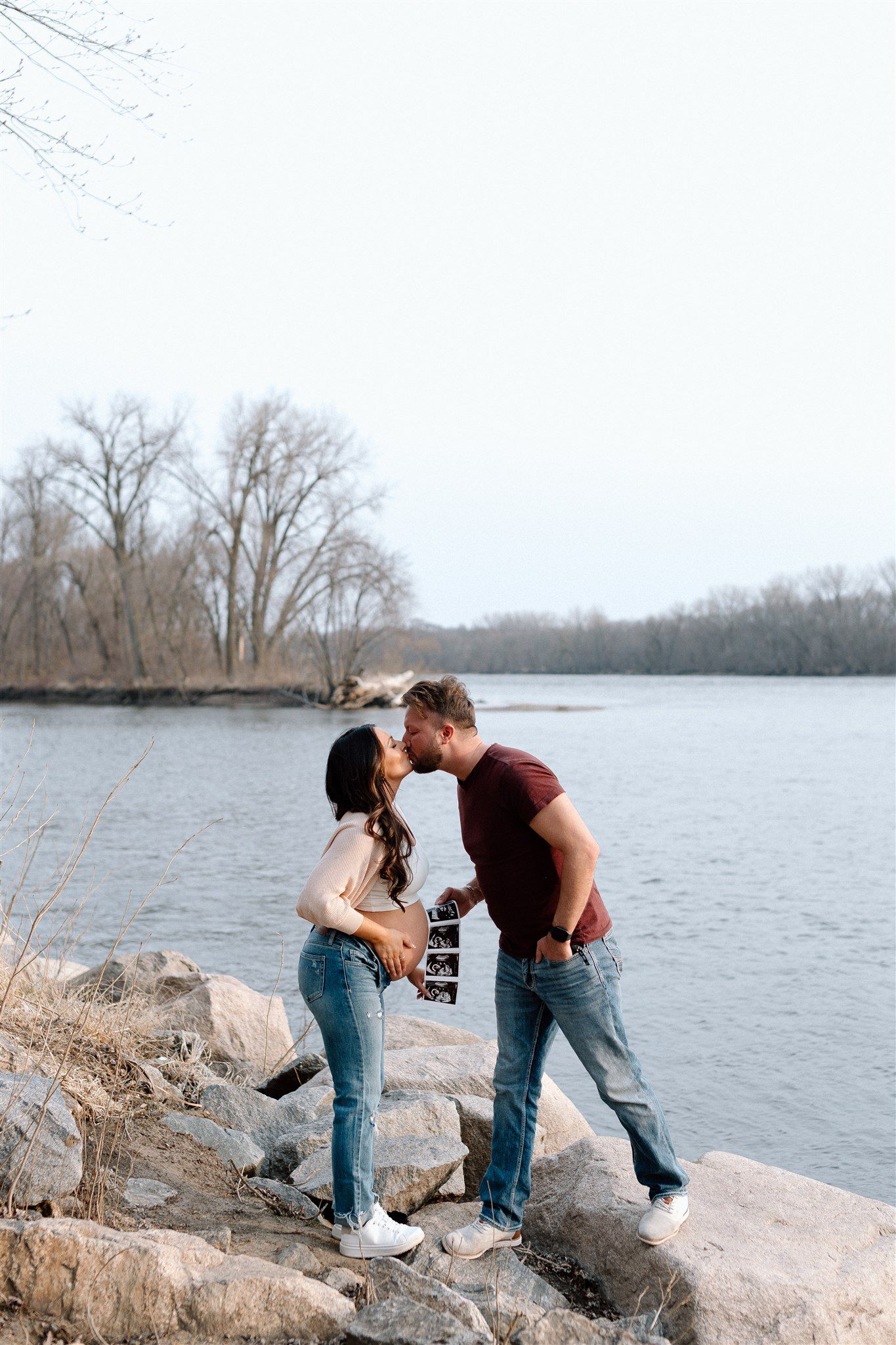 Expecting couple during a maternity session along the Mississippi River in Minnesota, captured by Makayla Miranda Photo.