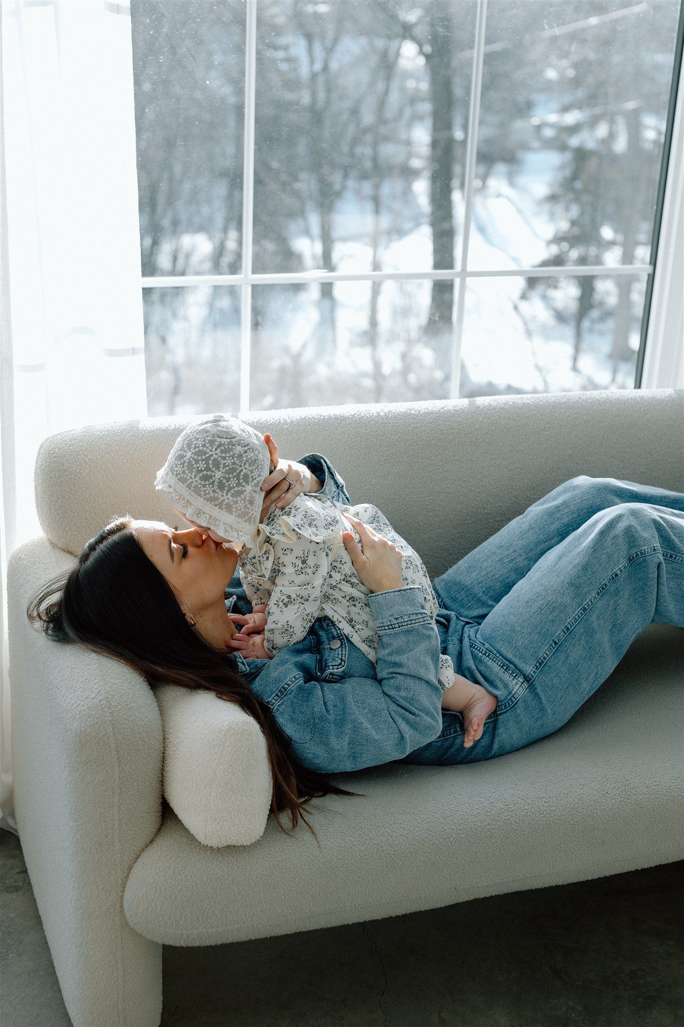 Mother holding her baby during an indoor studio session, captured by Makayla Miranda Photo.