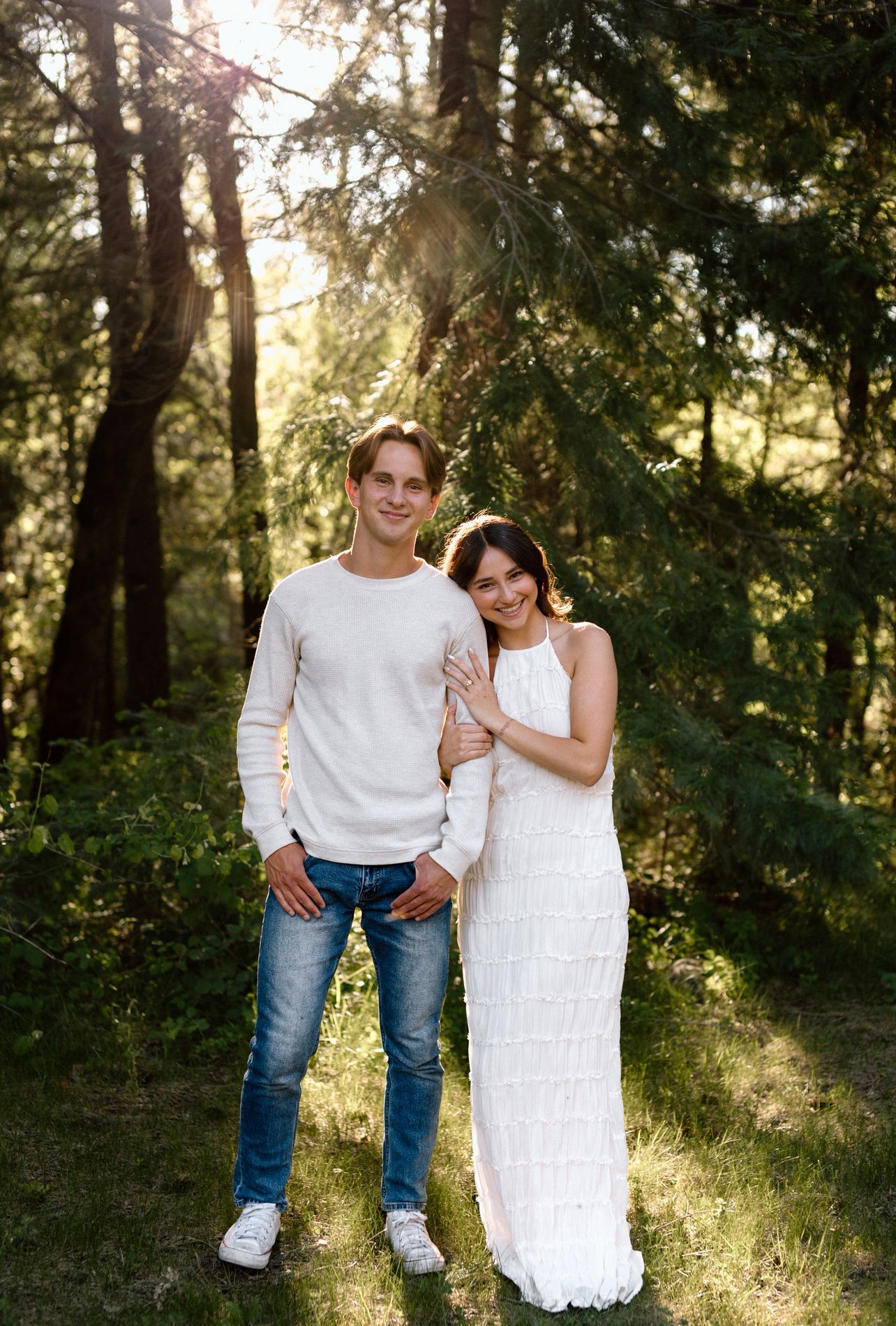 Couple posing for their engagement session among the trees in Lassen Volcanic National Park, Northern California, captured by MMP