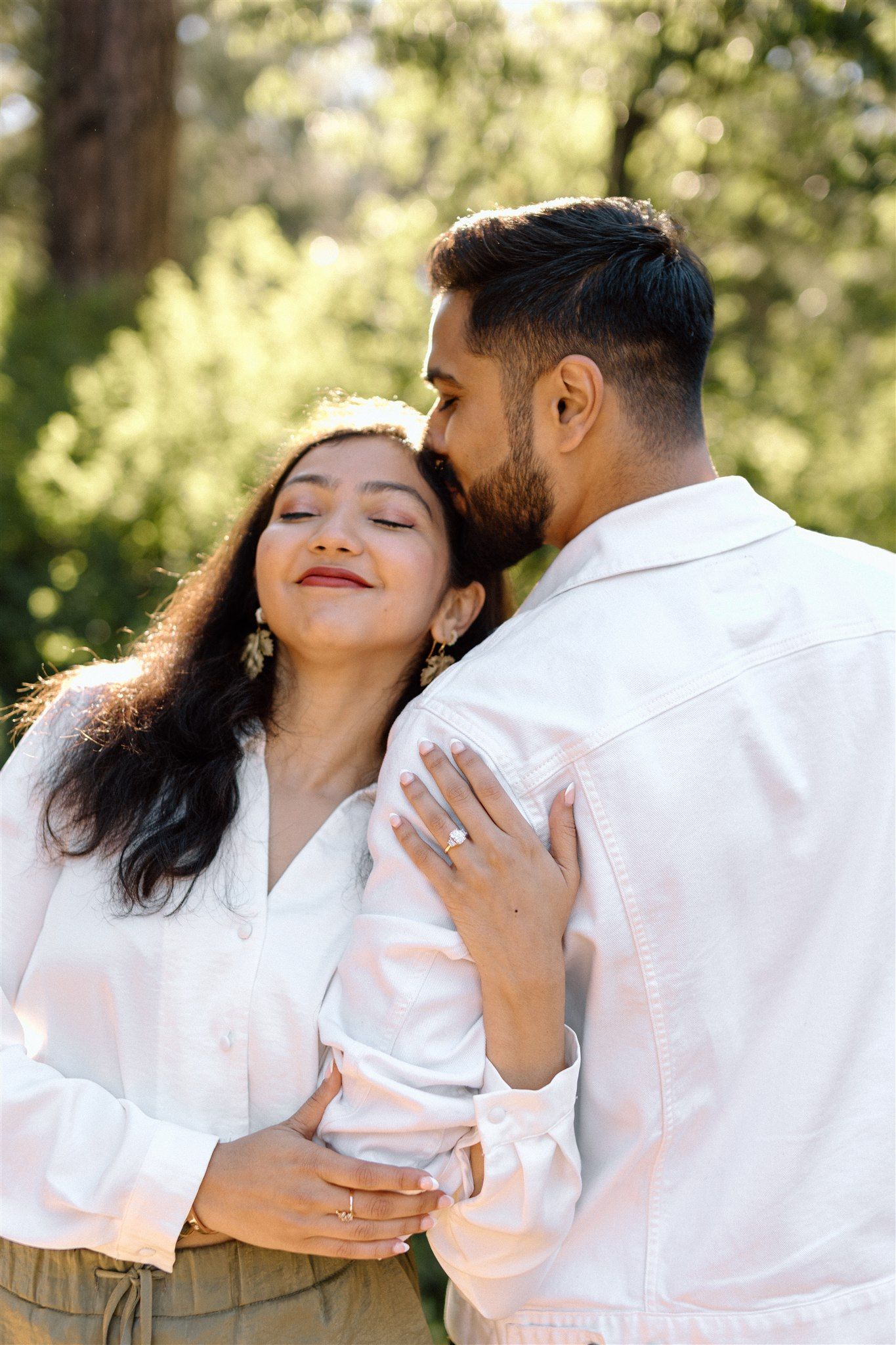 Couple posing for their engagement session at Burney Falls in Northern California, captured by Makayla Miranda Photo.