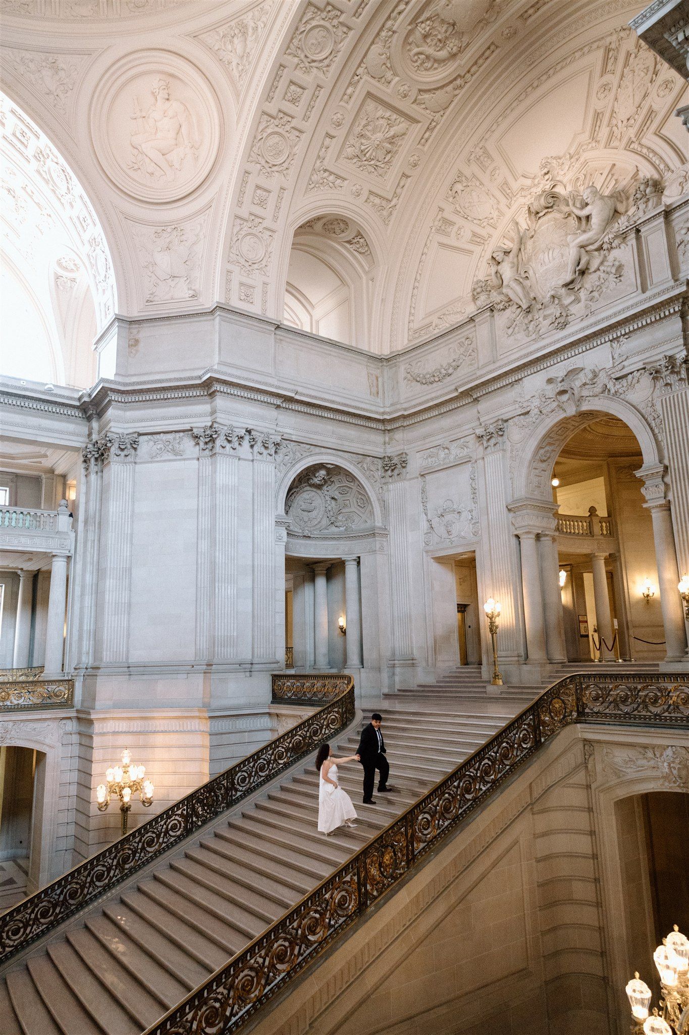Couple posing during their engagement session at San Francisco City Hall, captured by Makayla Miranda Photo.