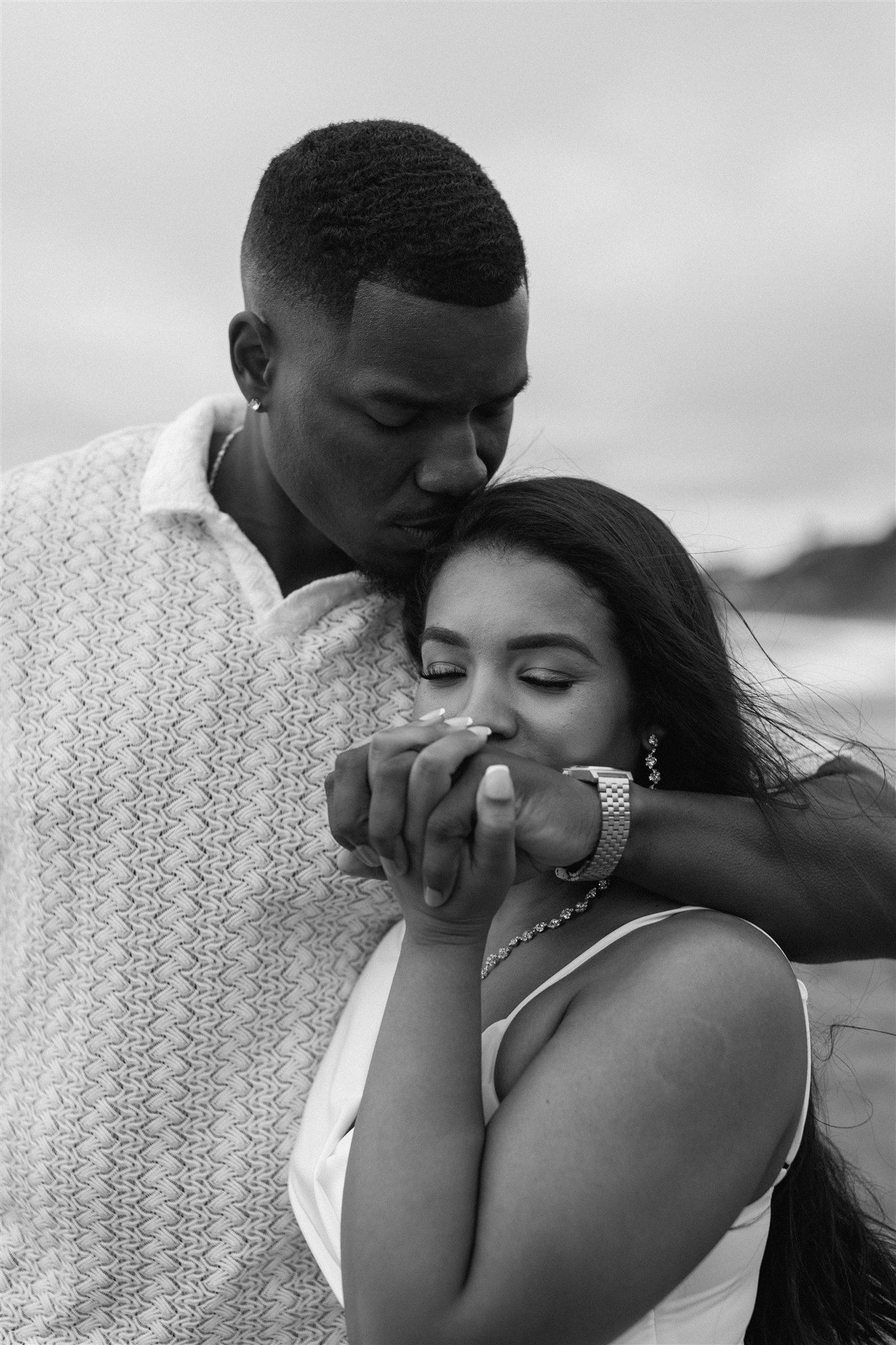 Couple posing for their engagement session at Baker Beach in San Francisco, California, captured by Makayla Miranda Photo