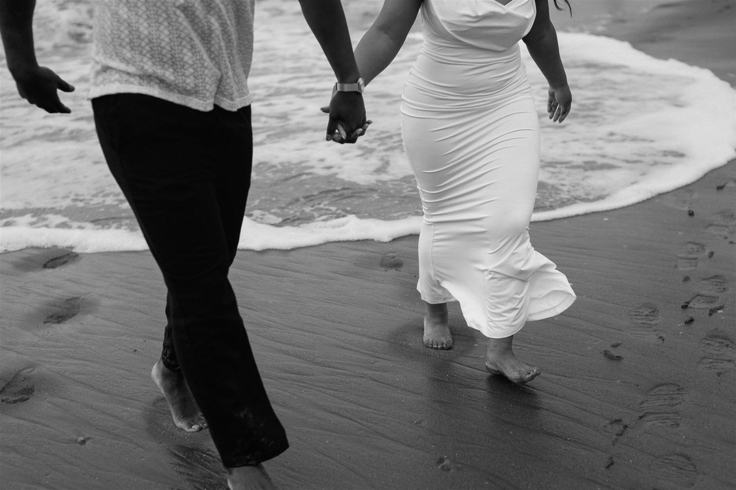 Couple posing for their engagement session at Baker Beach in San Francisco, California, captured by Makayla Miranda Photo