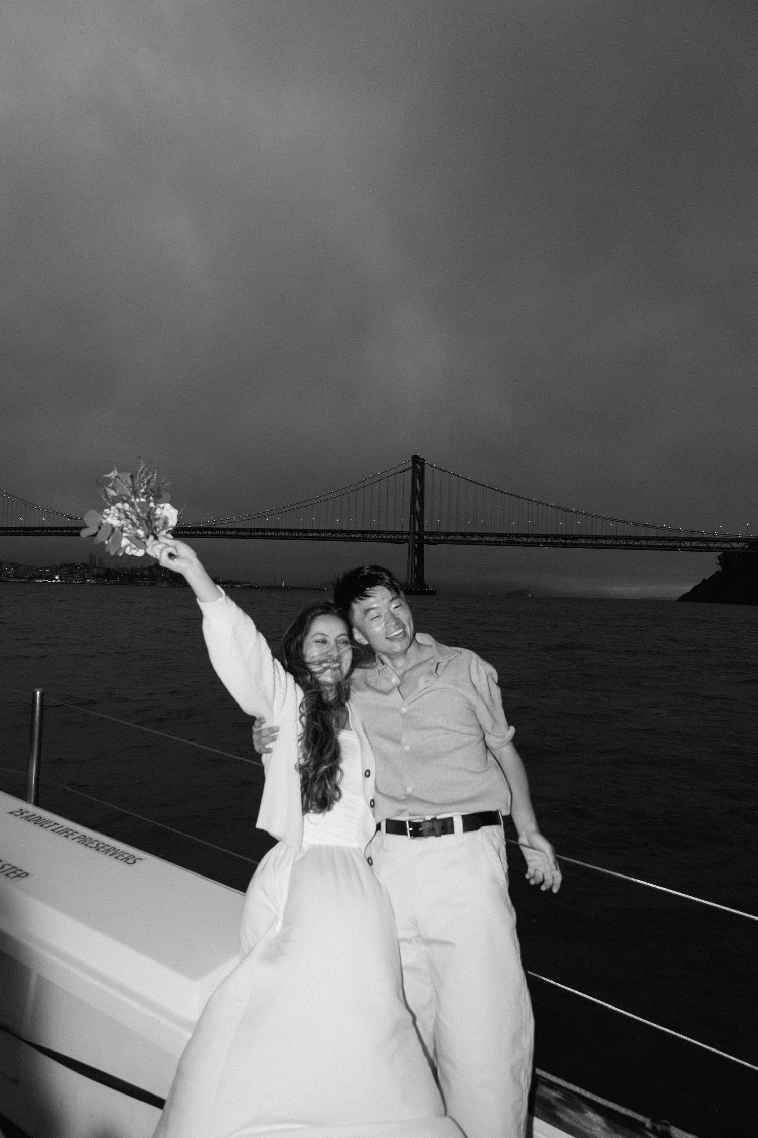Couple posing for their engagement session on a yacht in San Francisco, California, captured by Makayla Miranda Photo