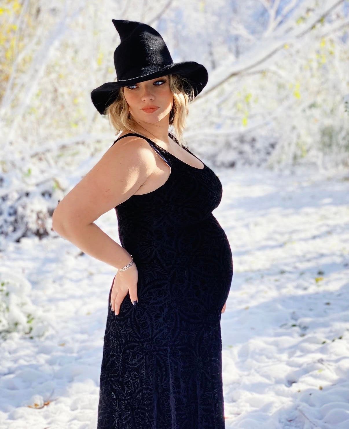 maternity photography 25 weeks pregnant witch themed maternity shoot snowy backdrop Millbury MA