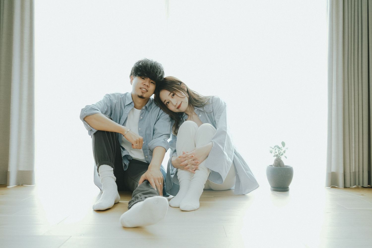 光あふれる窓辺で寄り添うご夫婦のやさしい記念写真