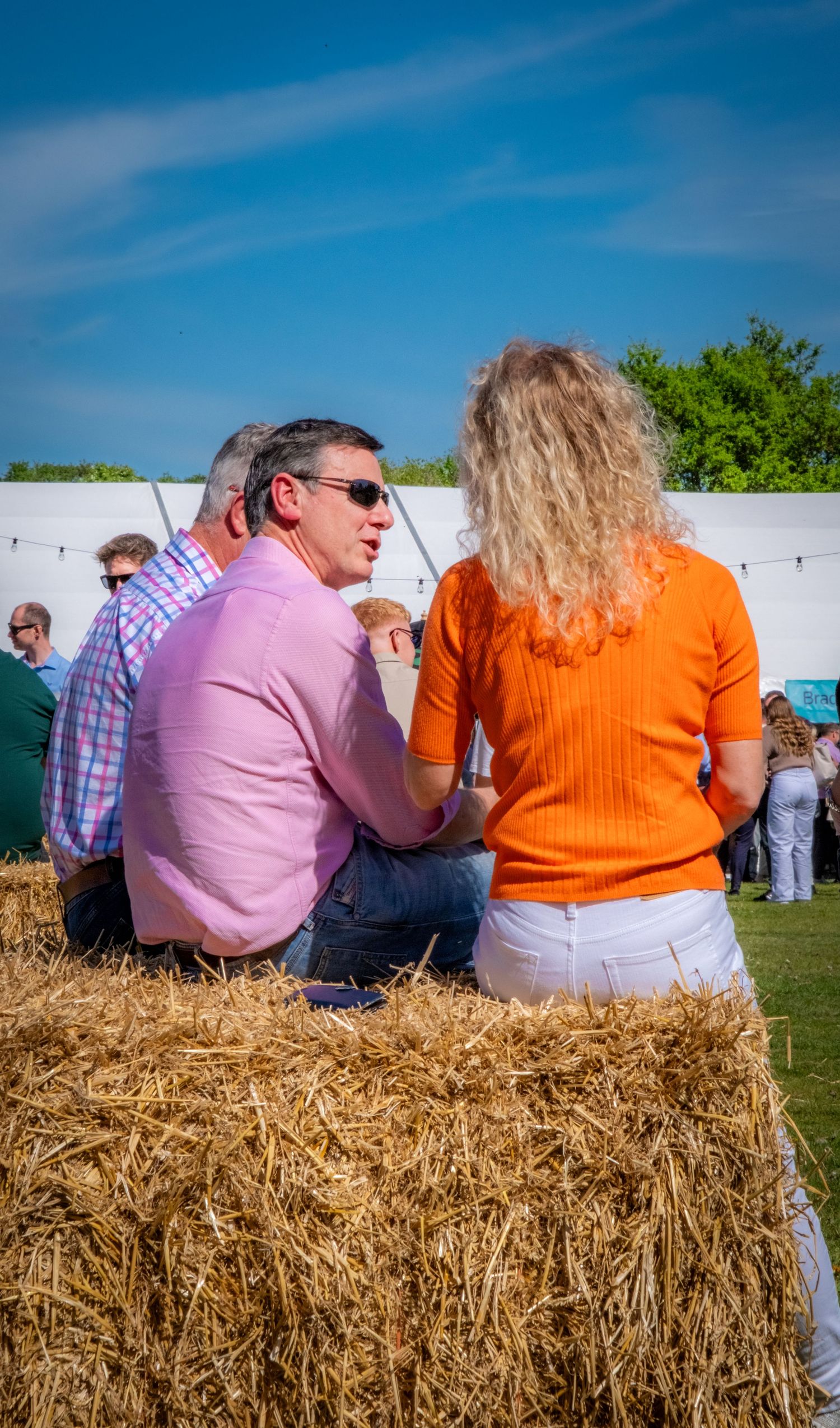 Business sponsors enjoying a networking charity event in the sunshine