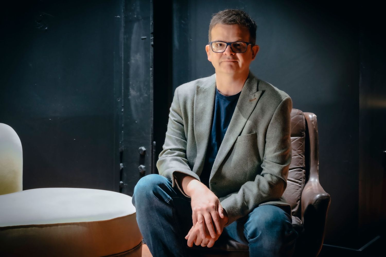 Relaxed professional portrait of business consultant in modern office environment