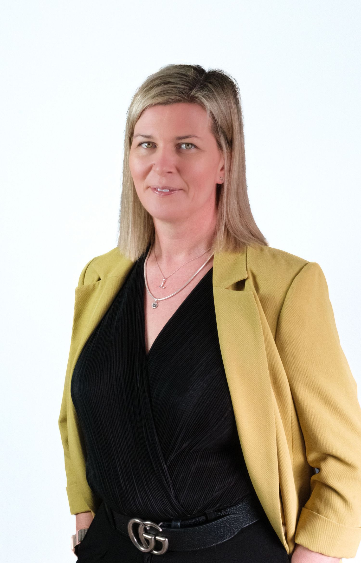 Professional headshot of business consultant in modern office environment