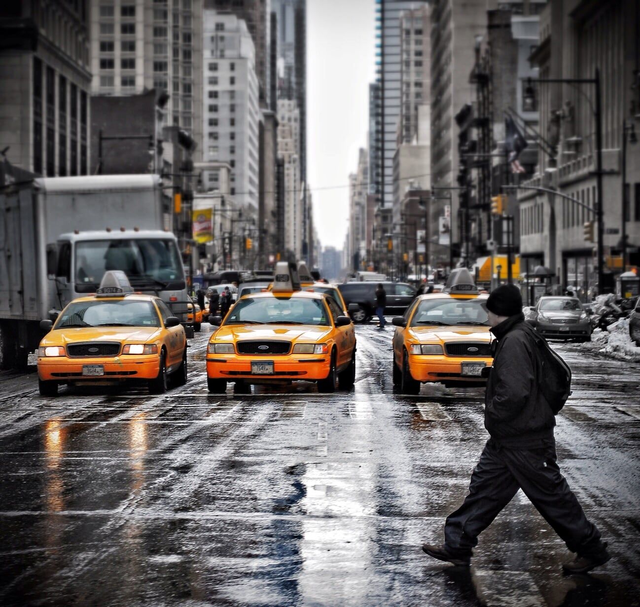 Perfectly timed image of a man crossing a busy street in New York city.