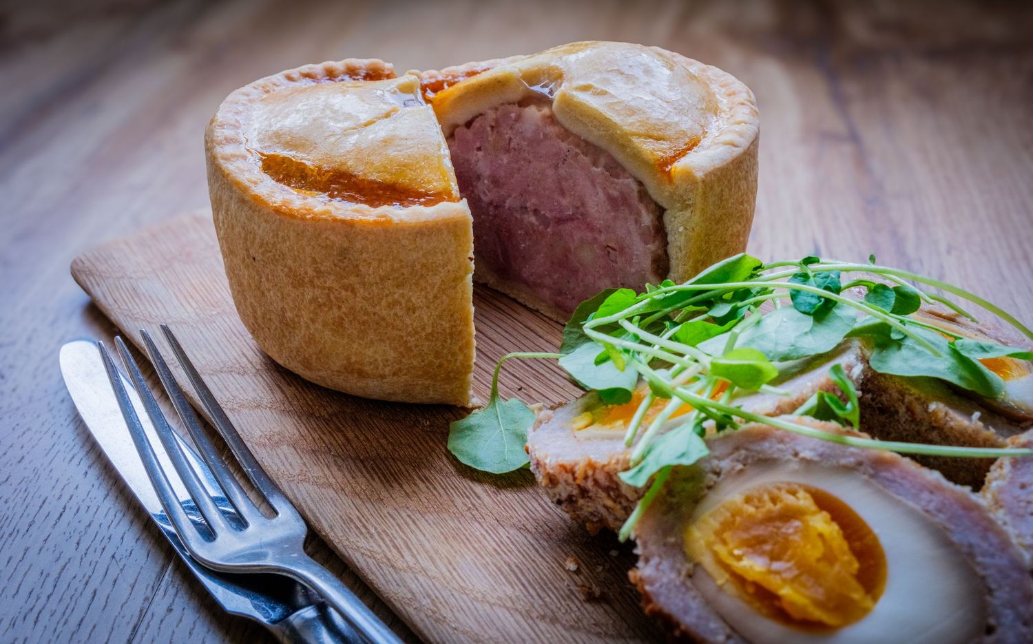 Food photograph of a delicious giant pork pie in a South Yorkshire restaurant, styled to highlight texture and presentation