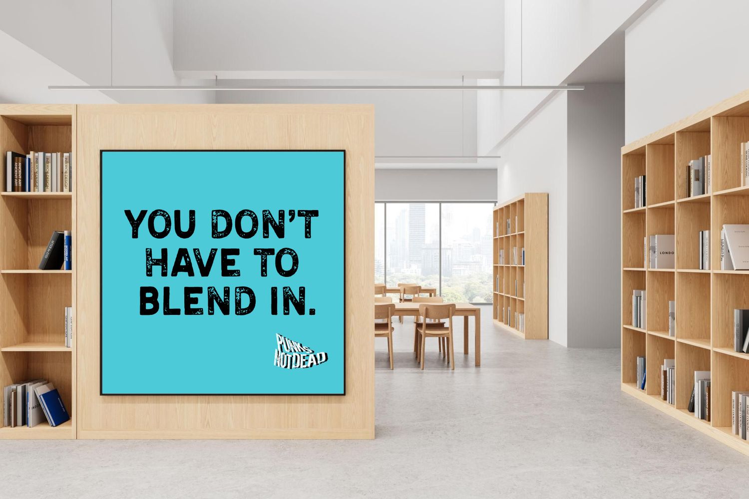Teal motivational poster reading You Don't Have To Blend In displayed in modern library.