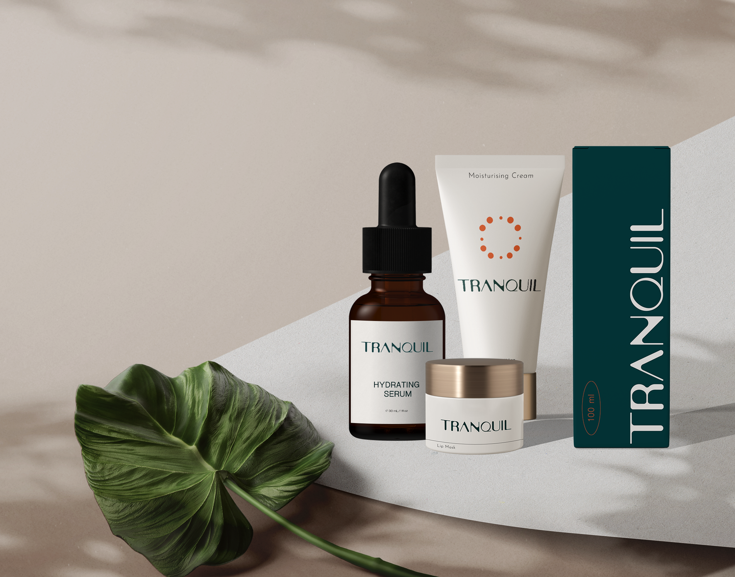 Tranquil skincare product set featuring a serum, moisturizer, and box displayed with a tropical leaf on beige background.