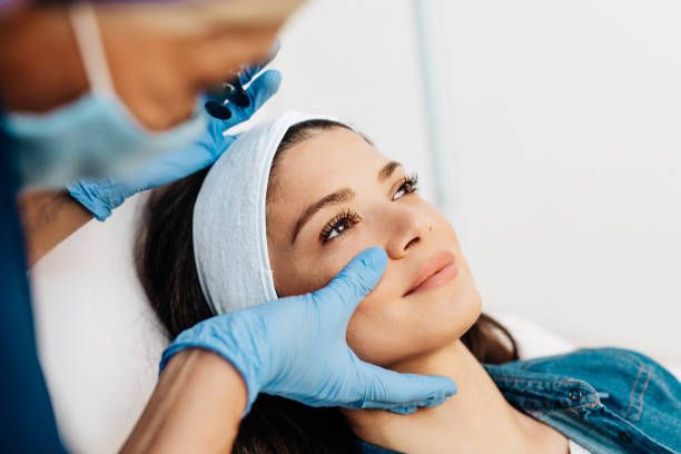 A young woman receives a treatment from a gloved aesthetician in a professional beauty clinic. Vanessa Charlotte Studios Wolverhampton