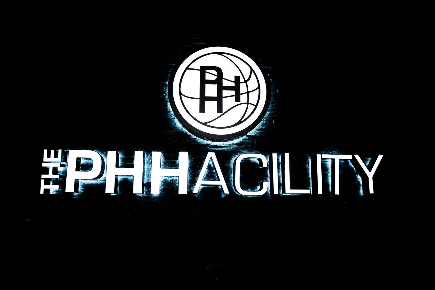 The PHH Facility logo with glowing blue text on a black background, featuring a basketball court emblem.