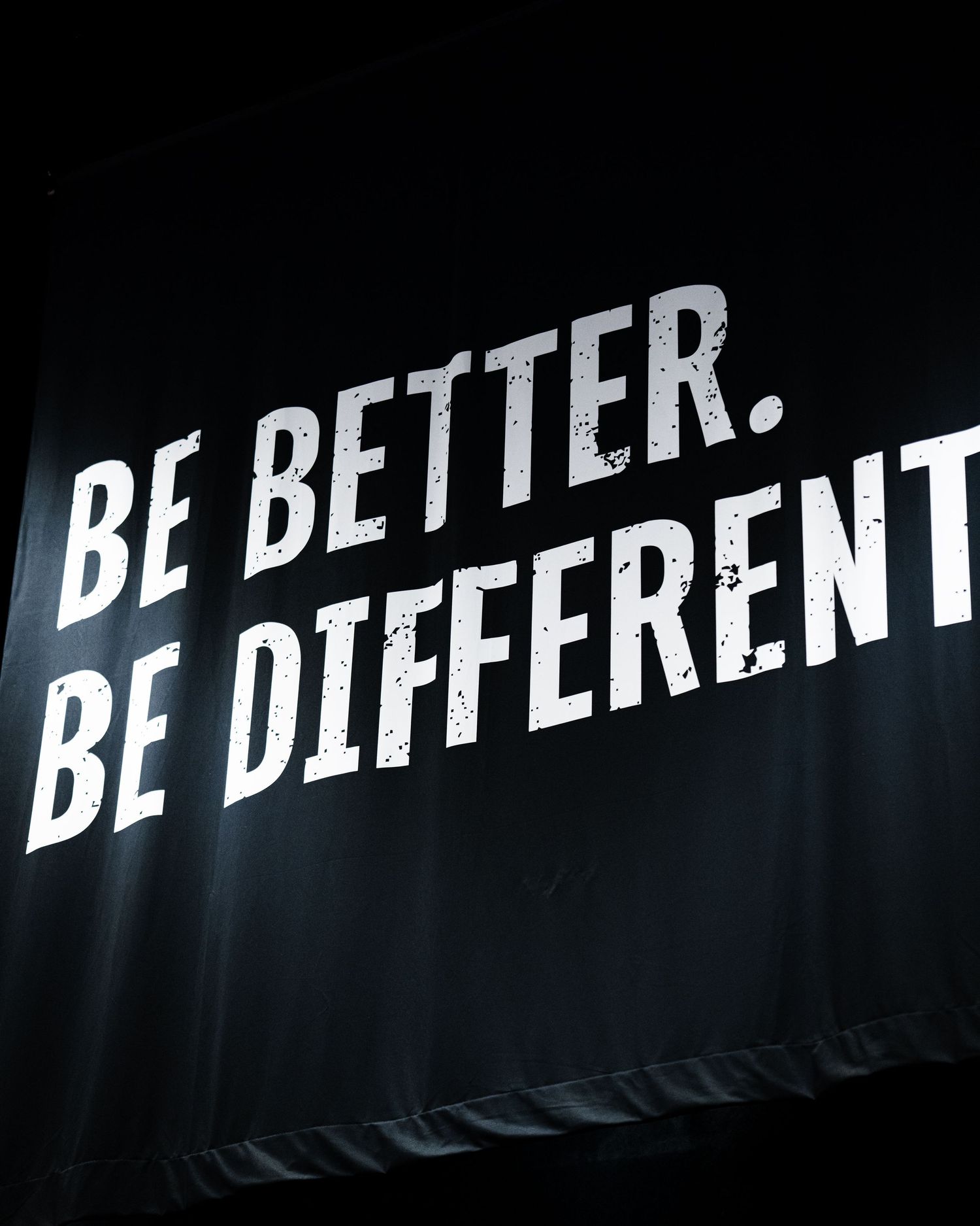 Bold white text on black banner reads Be Better Be Different at a basketball training event.