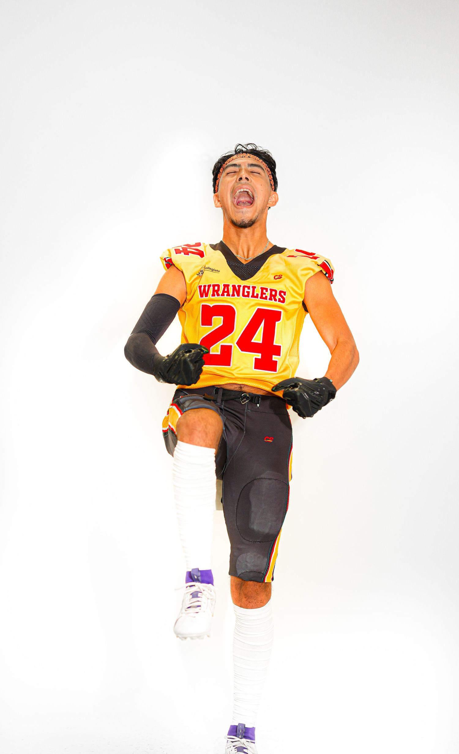 Football player #24 in gold Wranglers jersey poses dynamically on white background.