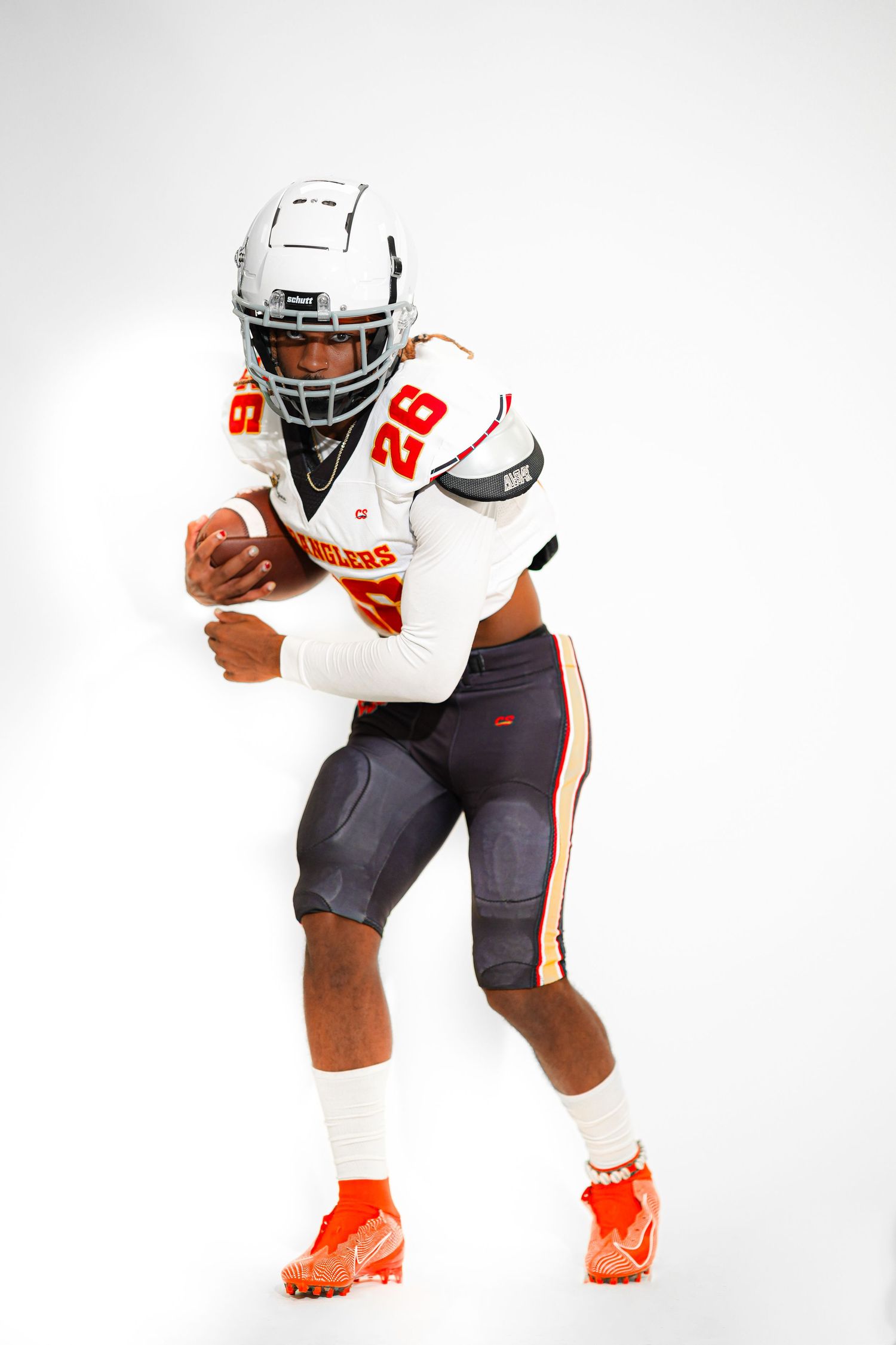 Football player wearing white jersey number 28 with orange accents, holding a ball in a running stance on white background.