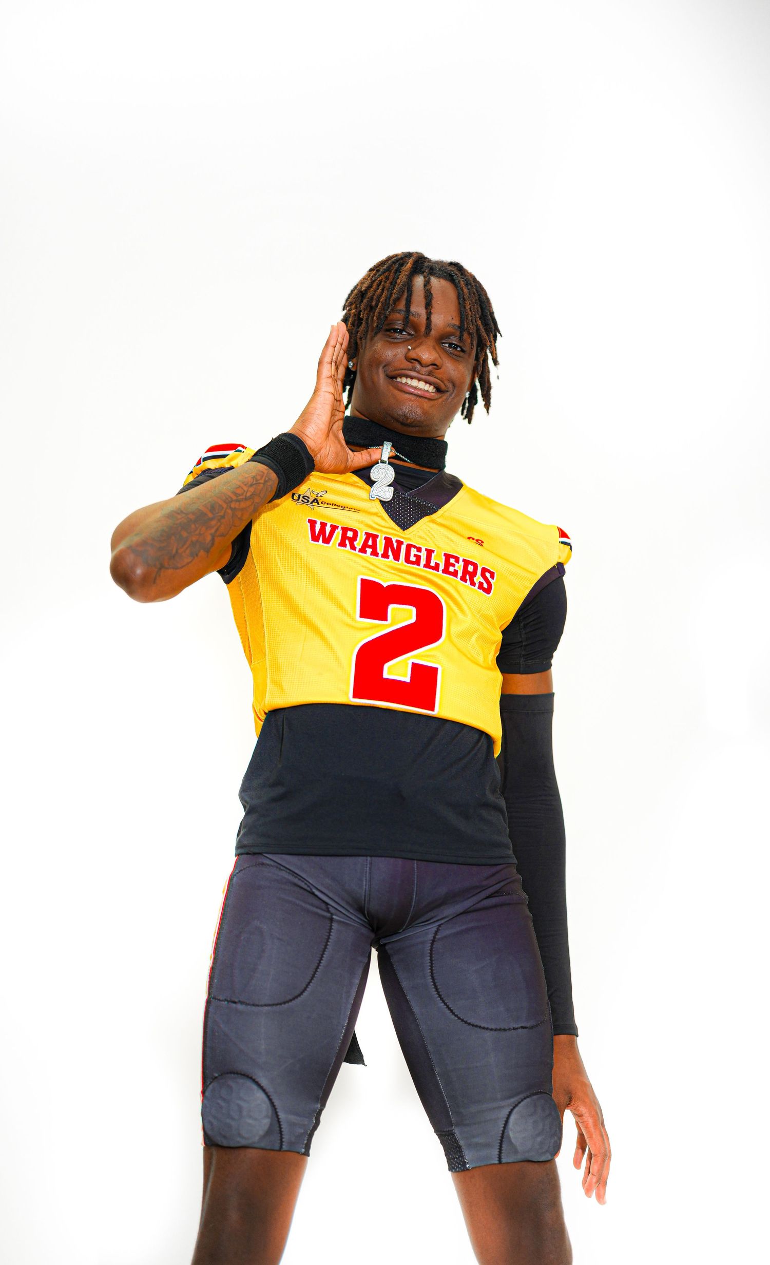 Player in yellow Wranglers #2 football jersey posing confidently against white background.