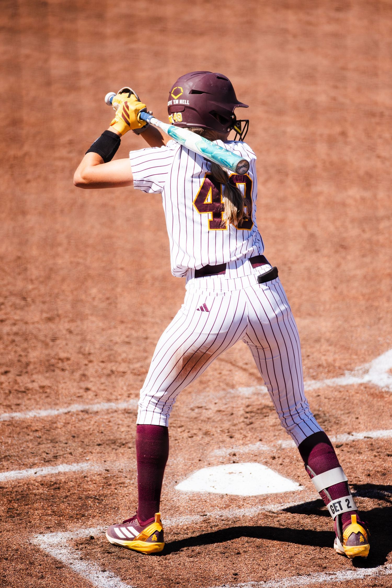 Arizona State Sun Devils softball player #41 in white pinstripe uniform stands ready to bat at home plate.
