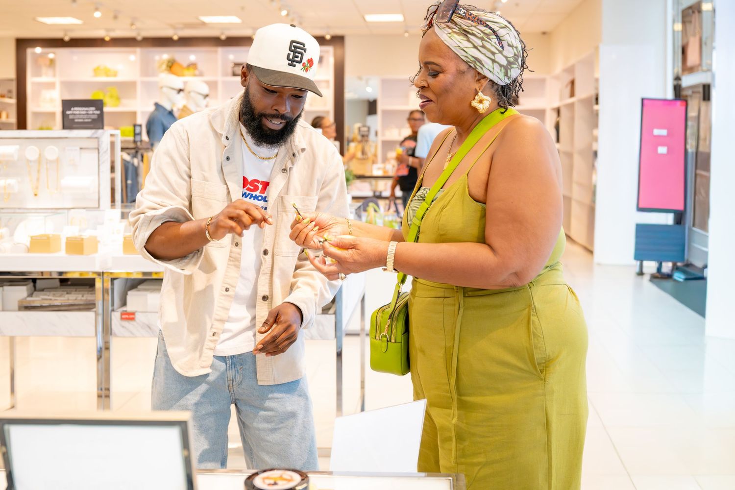 Man and woman browse beauty products at a retail store counter.