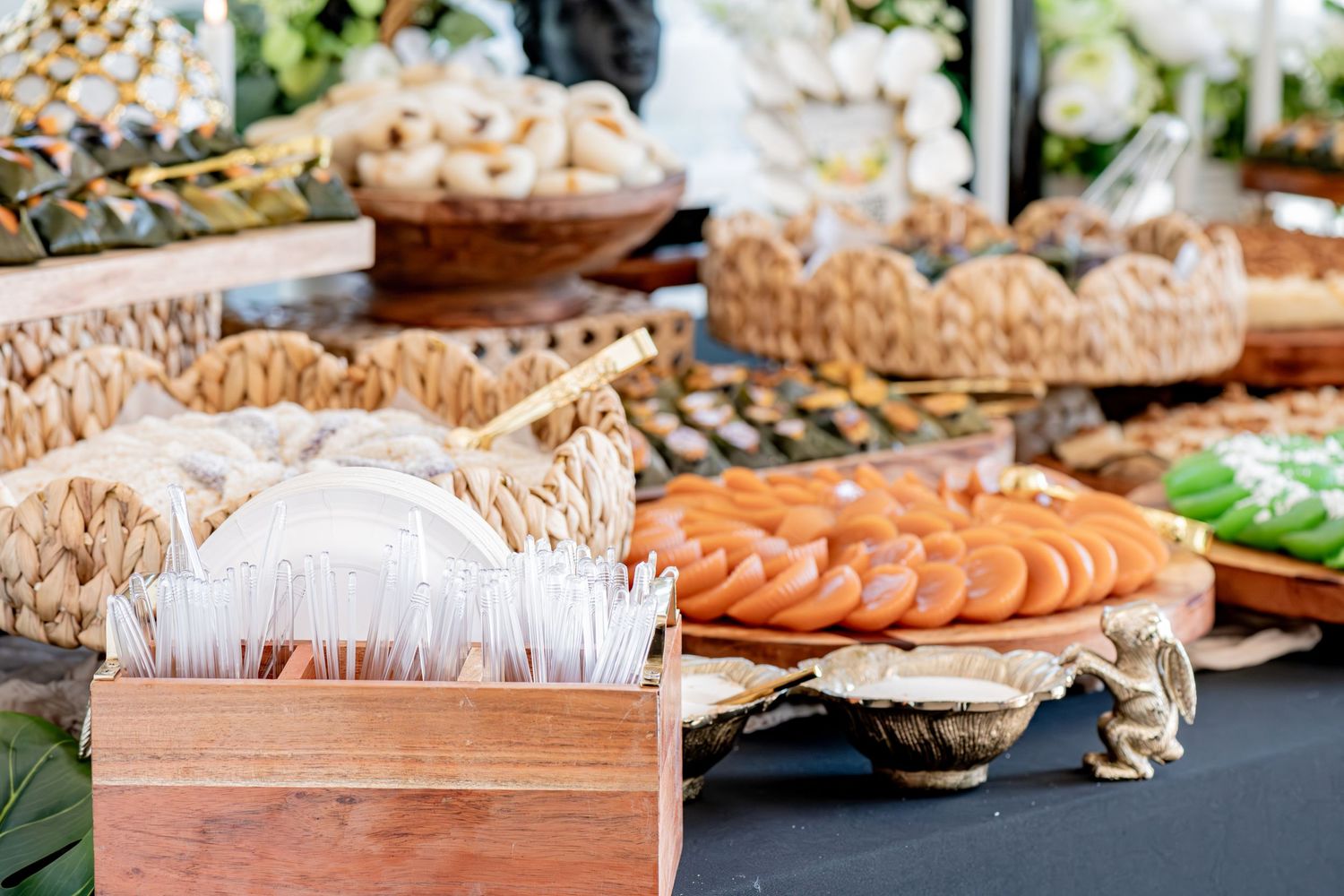 Assorted Filipino traditional snacks and pastries displayed on a catering buffet table spread.