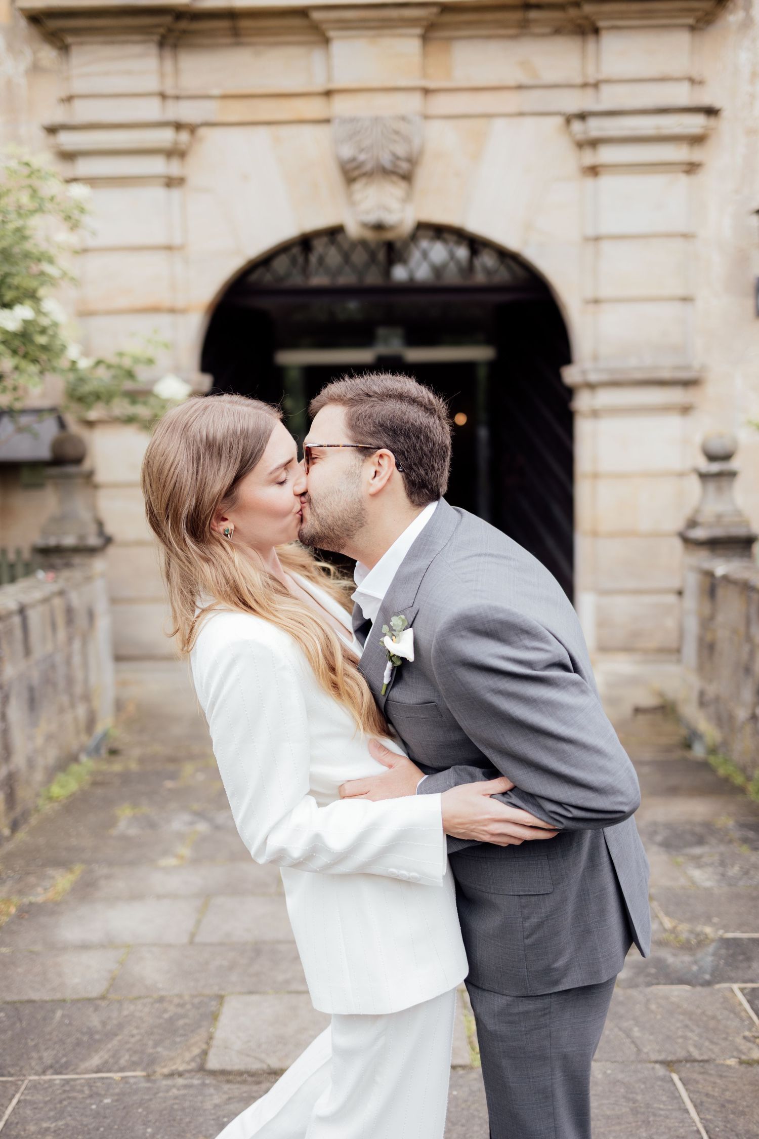 Bride and groom kiss romantically and excitedly after officially celebrating their standesamt wedding