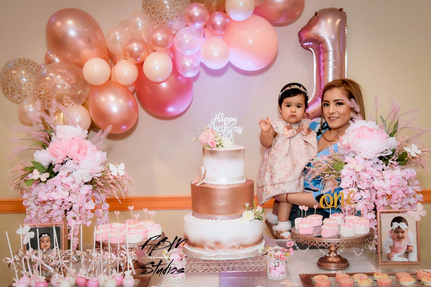 Elegant pink and rose gold first birthday party setup with balloon arch and tiered cake by FBM Studios in Ft Lauderdale Fl.