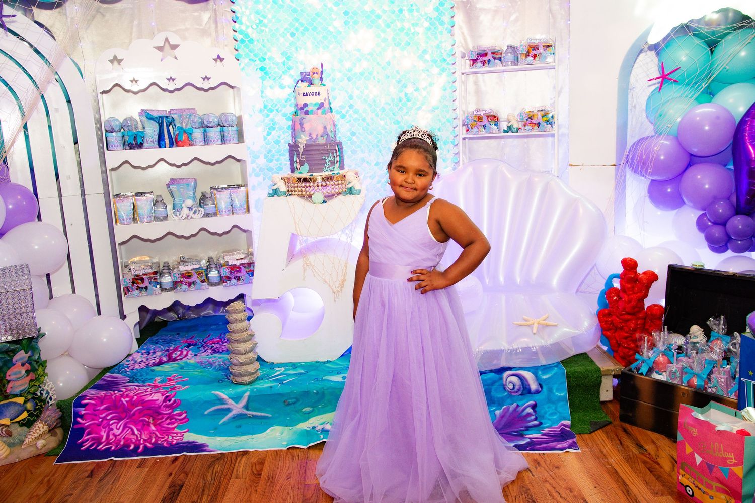 A purple and blue themed birthday party setup with balloon decorations and dessert tables by FBM Studios in Ft Lauderdale Fl.