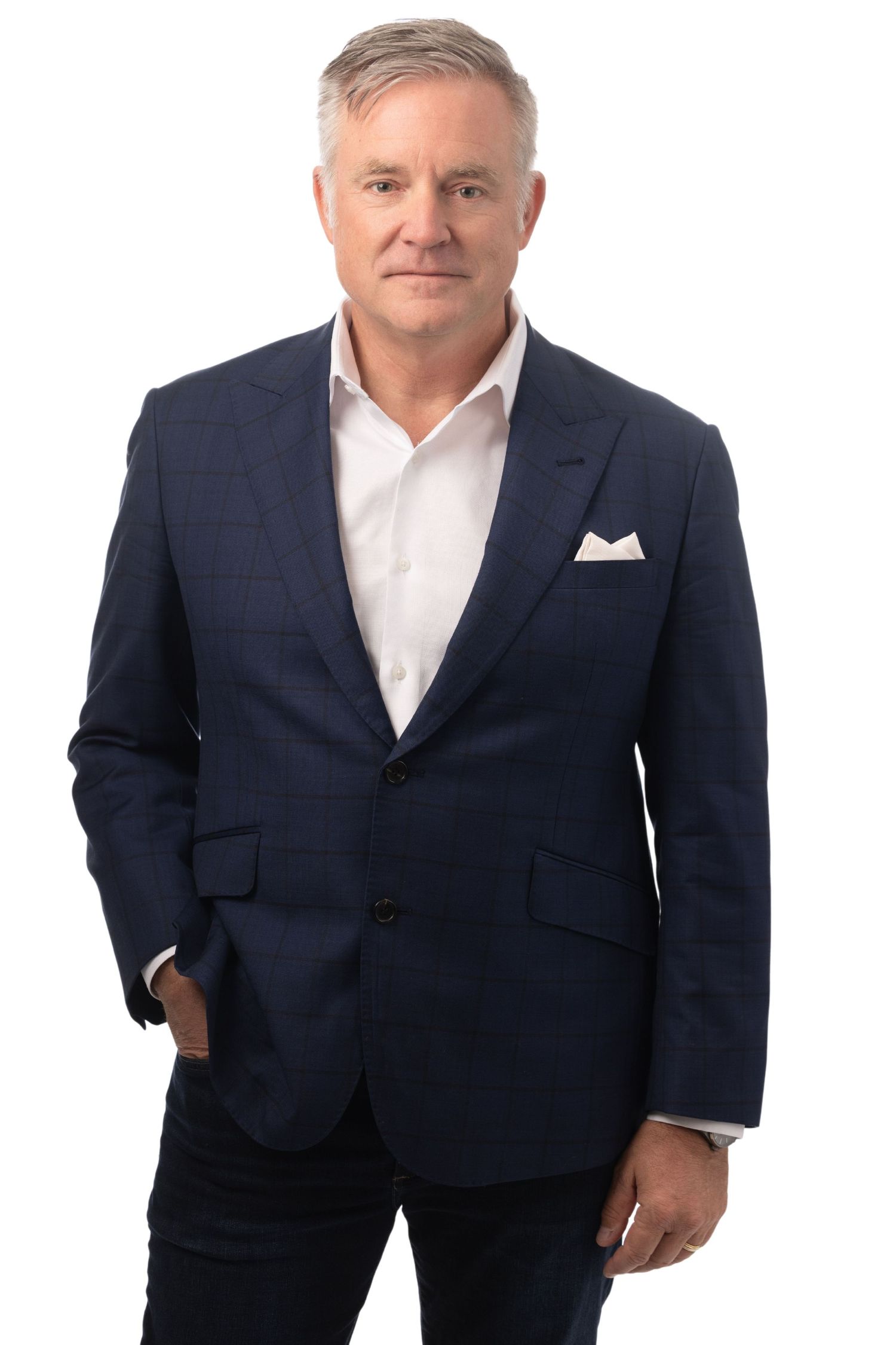 Middle-aged man with gray hair wearing a navy blue blazer and white shirt, posing professionally against white background.