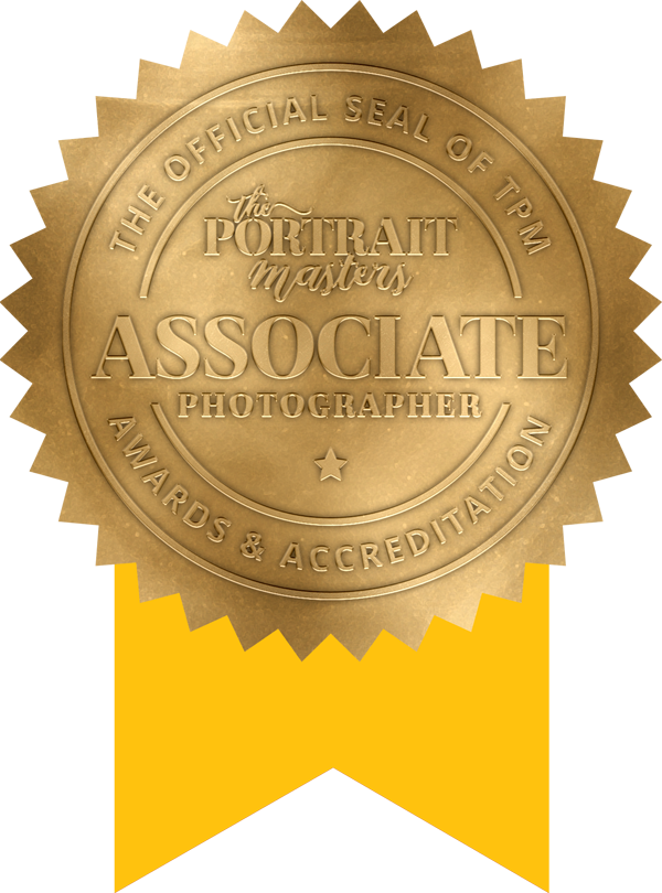 The Portrait Masters official Associate Photographer gold seal award accreditation badge.