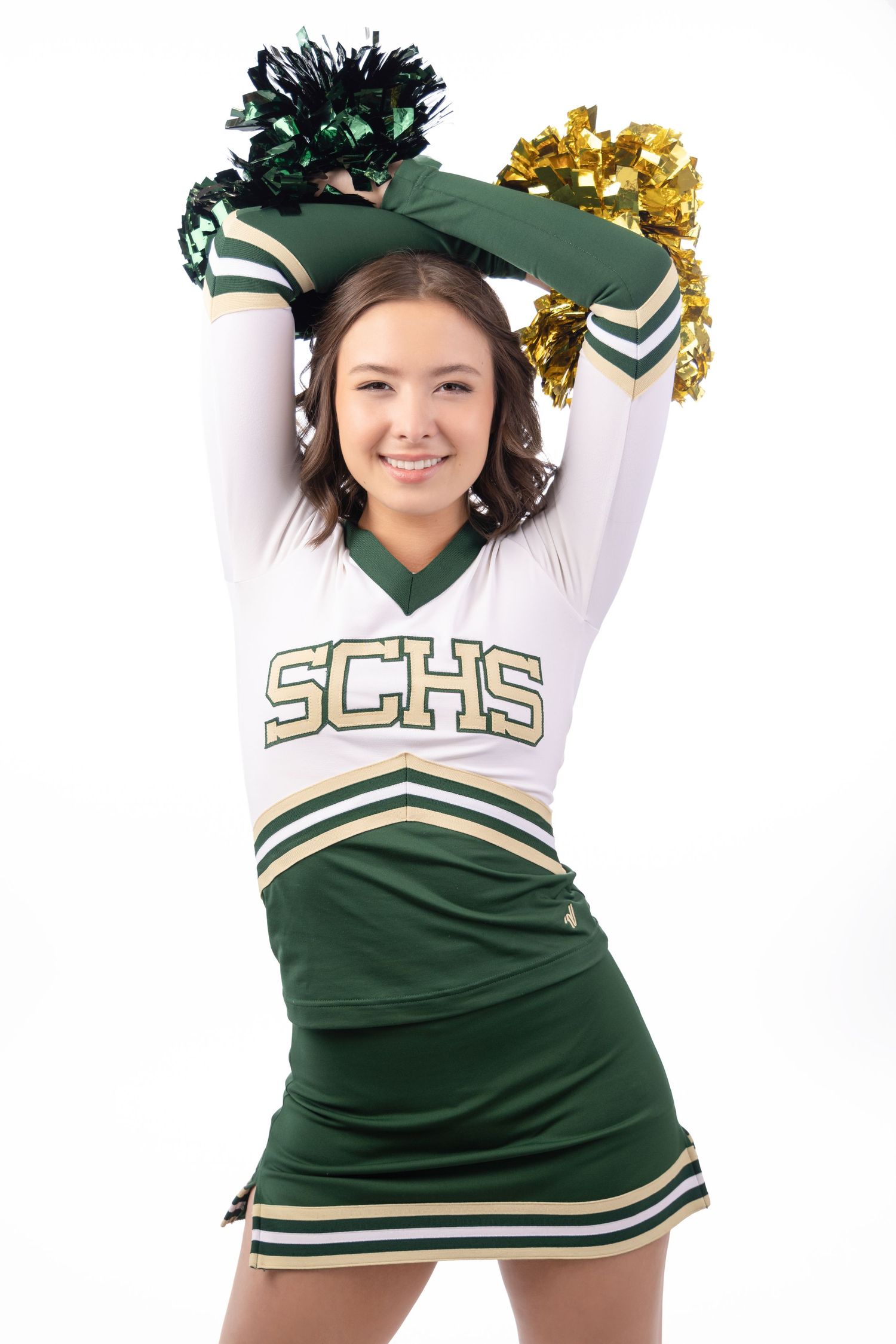 Smiling cheerleader in SCHS green and white uniform holding pom-poms overhead on white background.