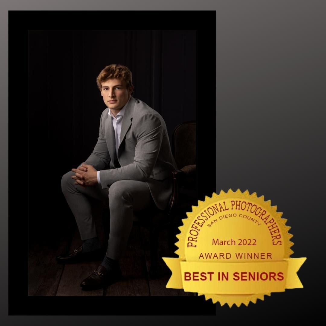 Young man in gray suit seated, winning Best in Seniors award from Professional Photographers San Diego County, March 2022.