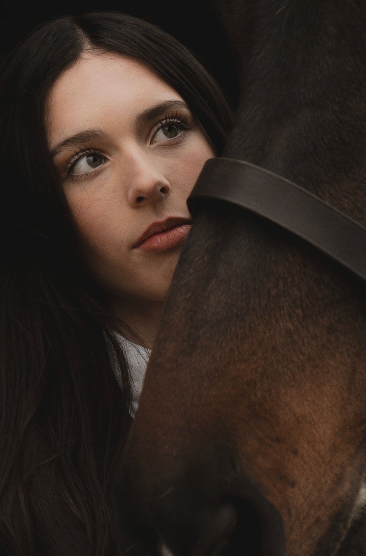 Close up photo of a horse and her owner.