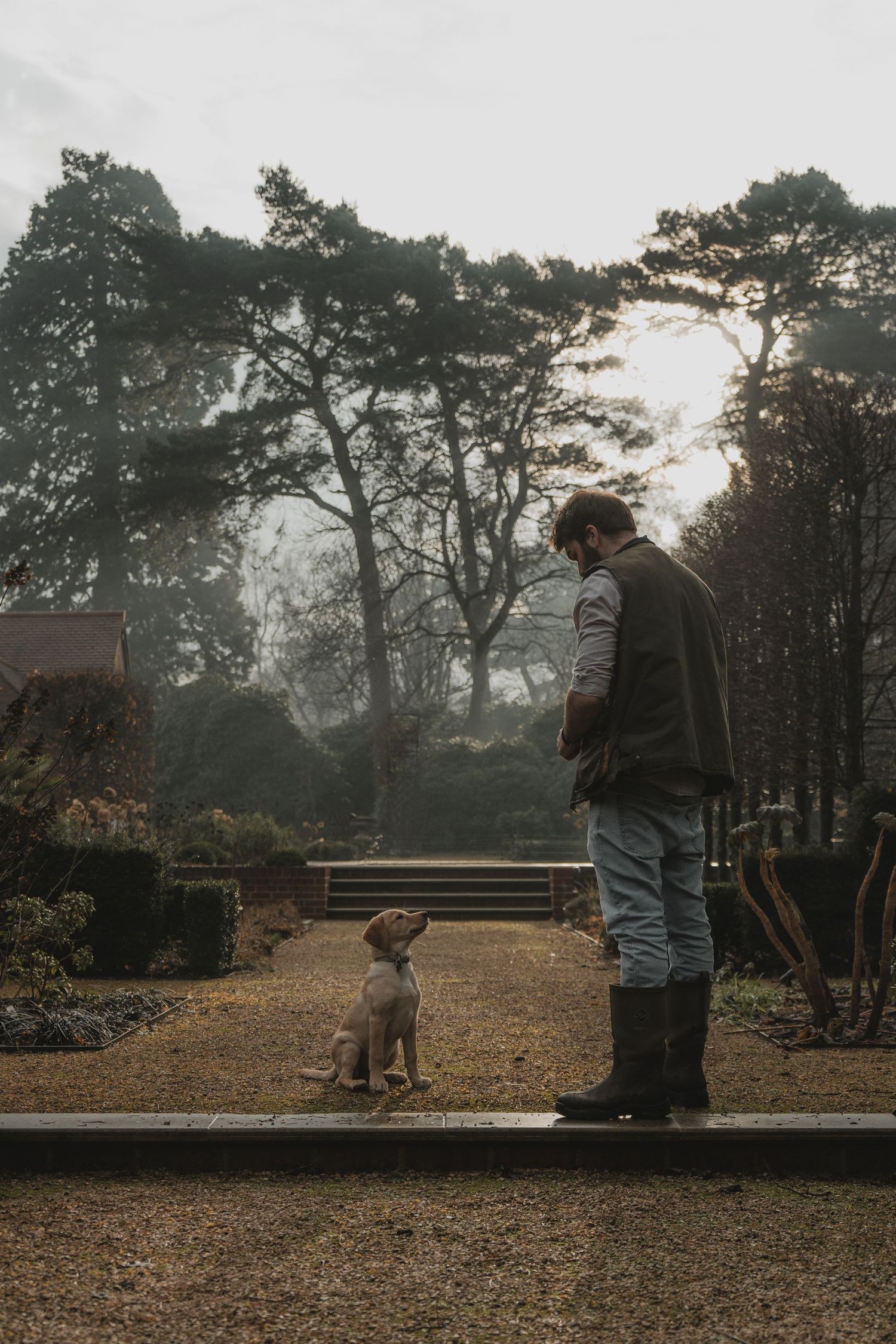 A labrador puppy and her owner whilst she waits to be given treats