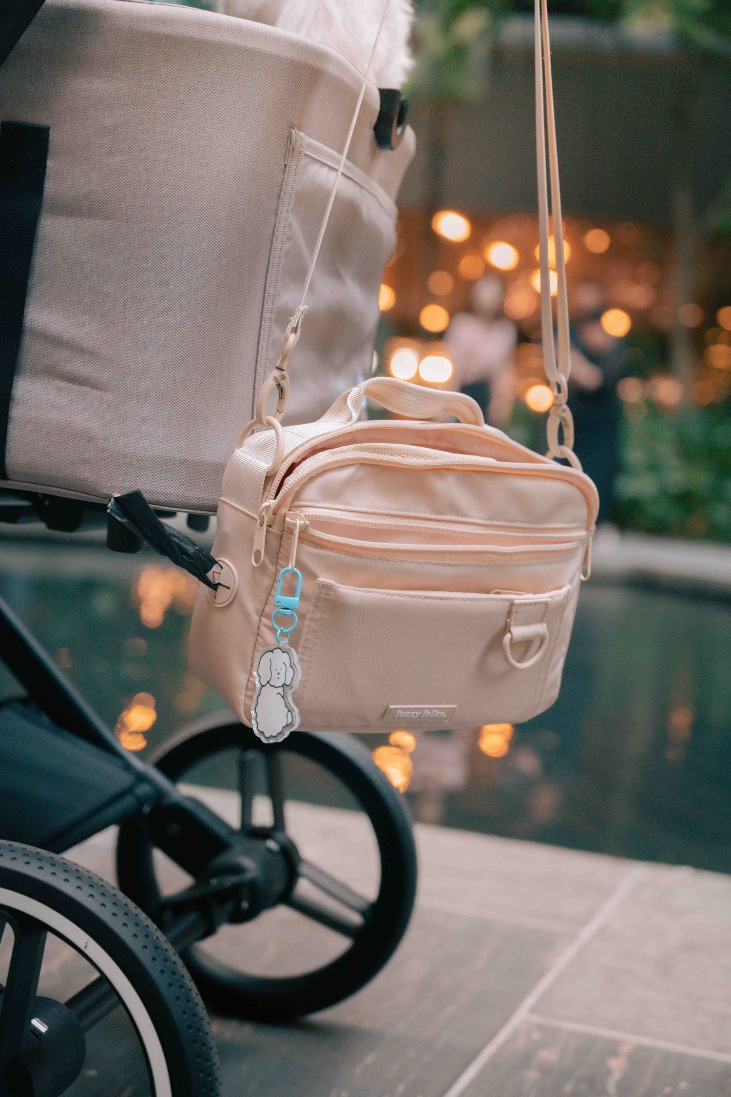 Close-up of a beige stroller bag attachment in evening lighting.