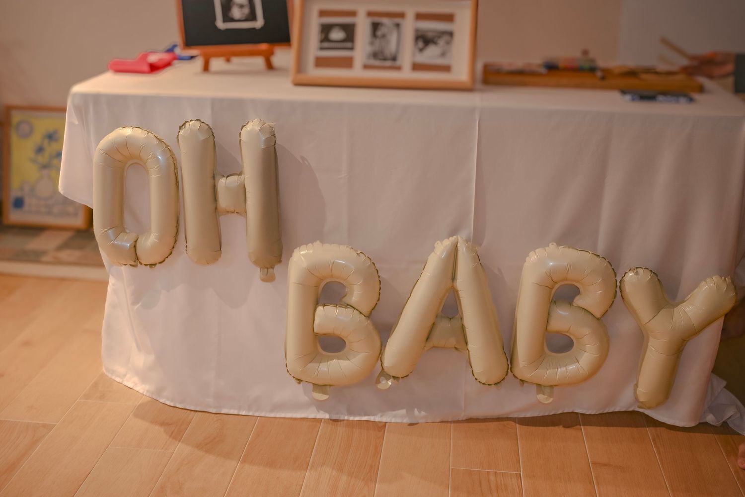 Gold balloon letters spelling 'BABY' arranged as party decoration.