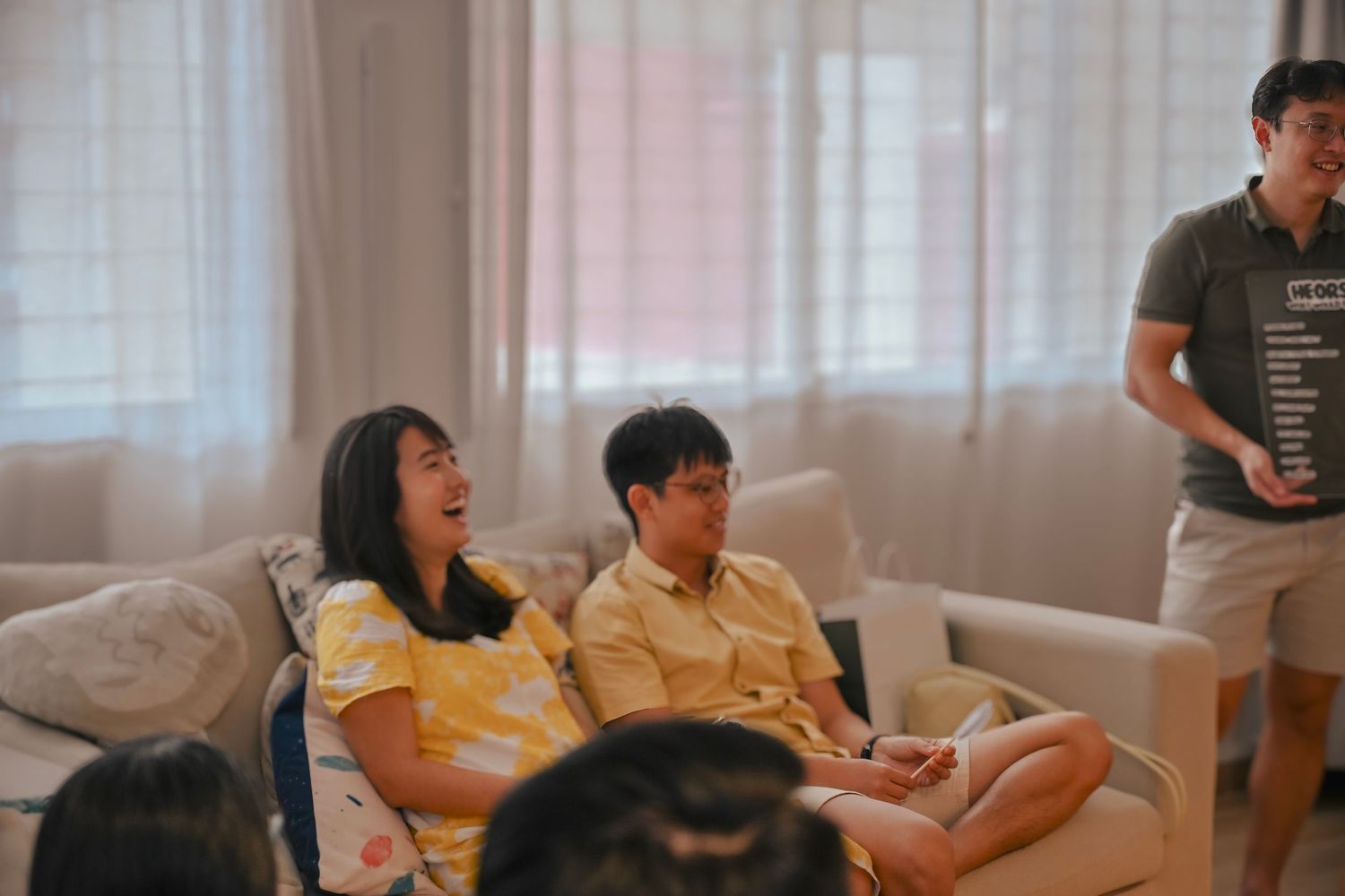 Group activity scene in a sunlit room with casual seating arrangements.