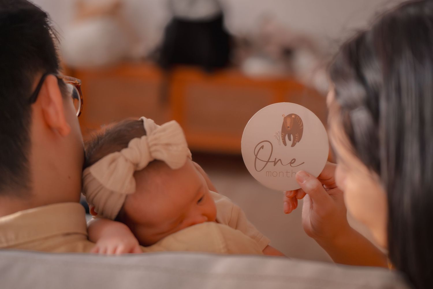 Intimate family moment with parent and baby sharing a close connection.