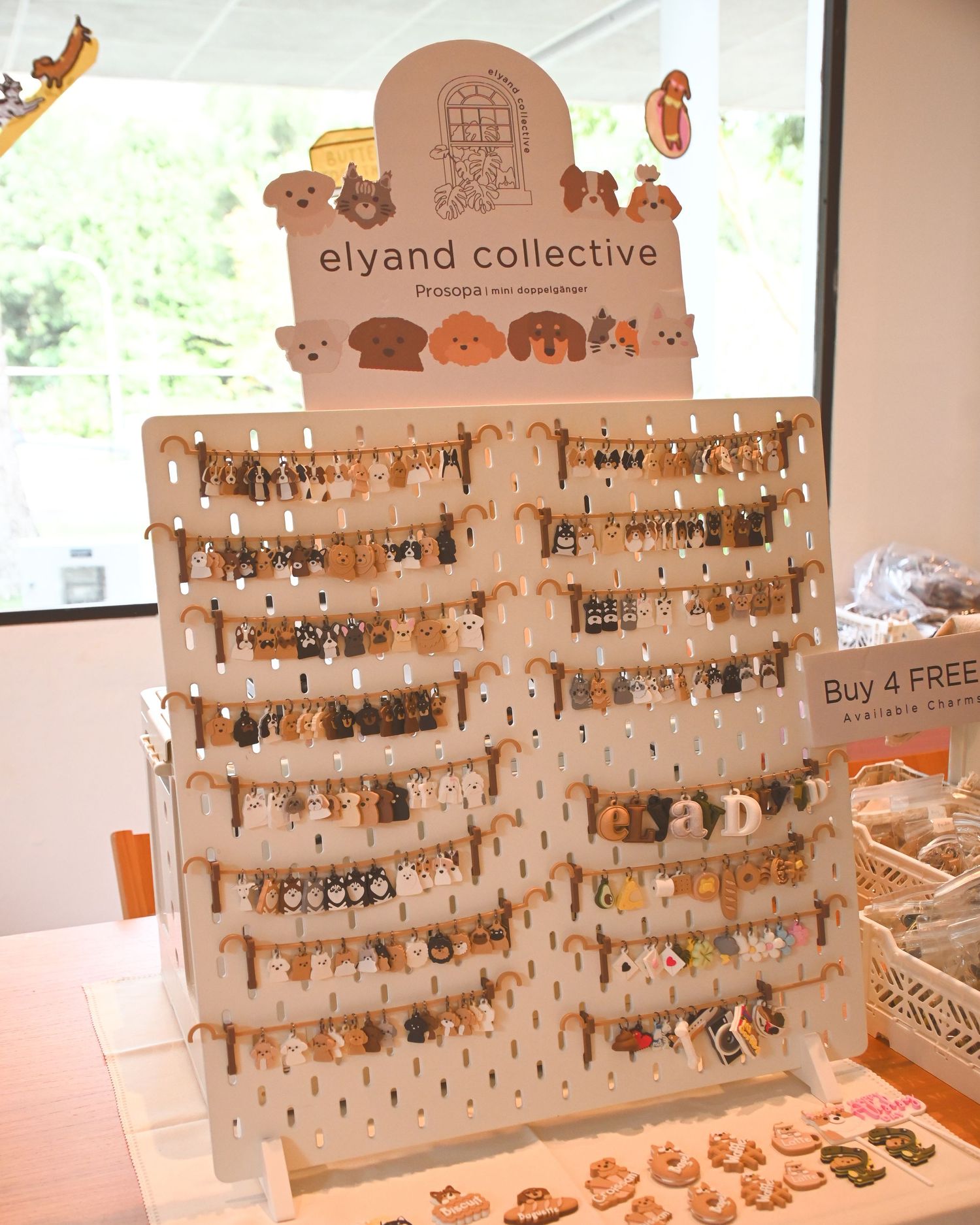 Display board with multiple hanging items and merchandise from a collective shop.