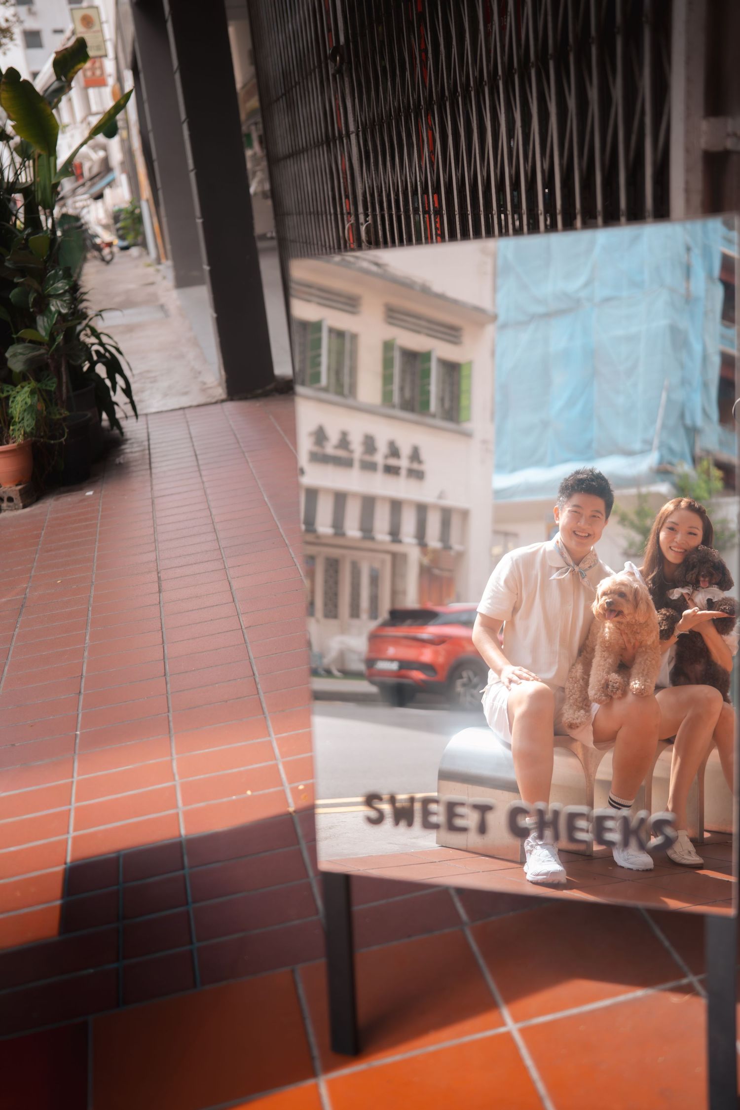 People sitting and relaxing on tiled steps outside a building in an urban setting.