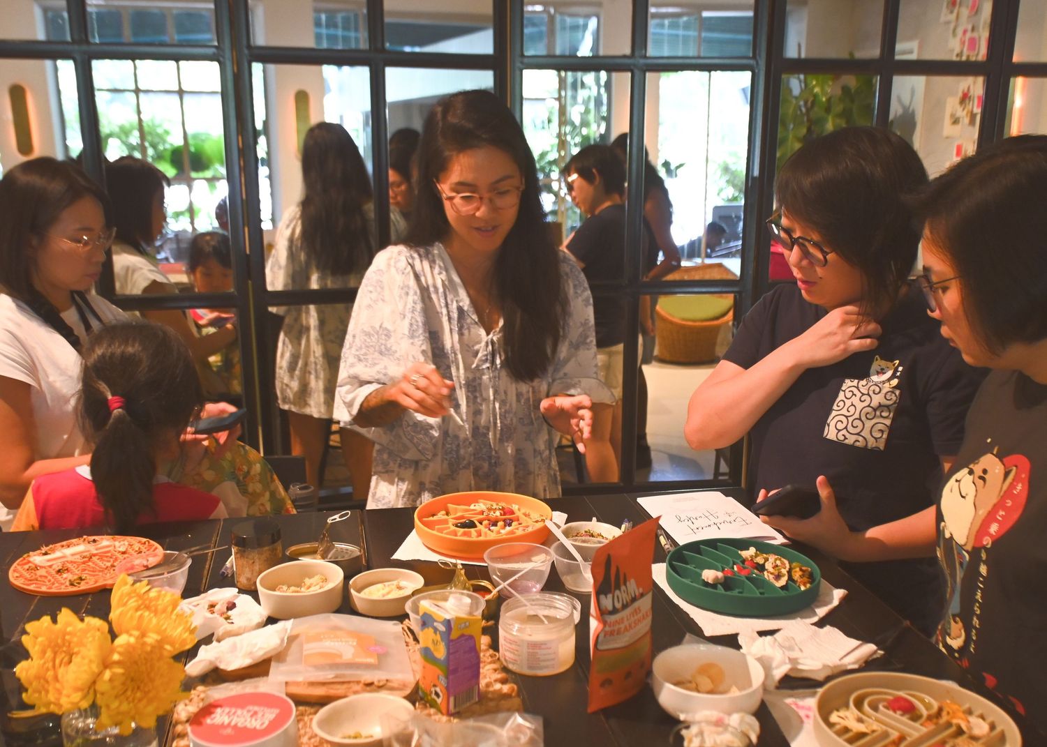 Group dining scene at a restaurant with food and drinks on the table.