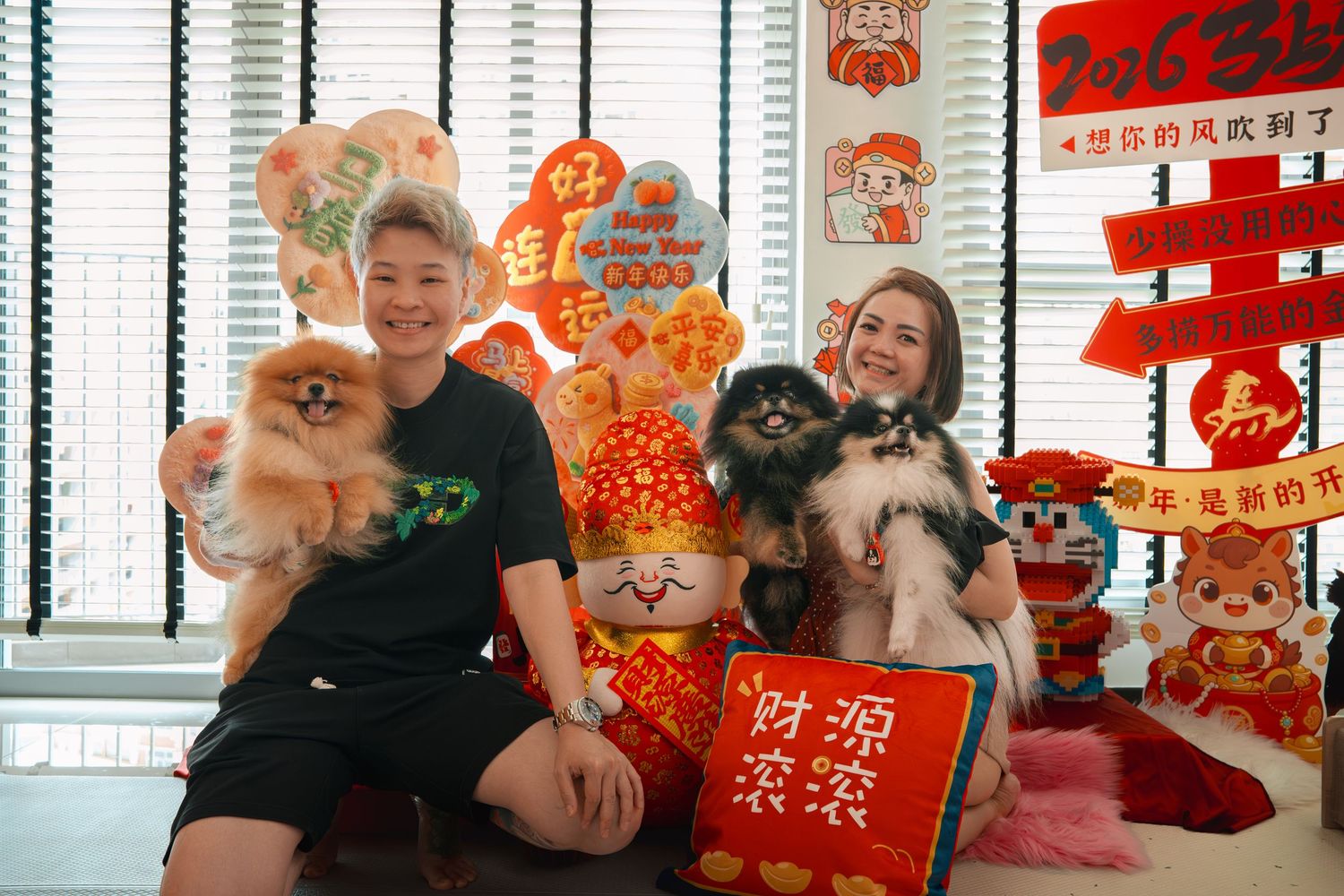 People celebrate Chinese New Year with traditional red decorations and festive ornaments in a bright interior setting.