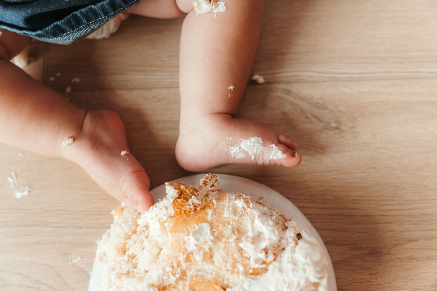 Baby girl toes' covered in cake during an in-home milestone session in Charlotte, NC.