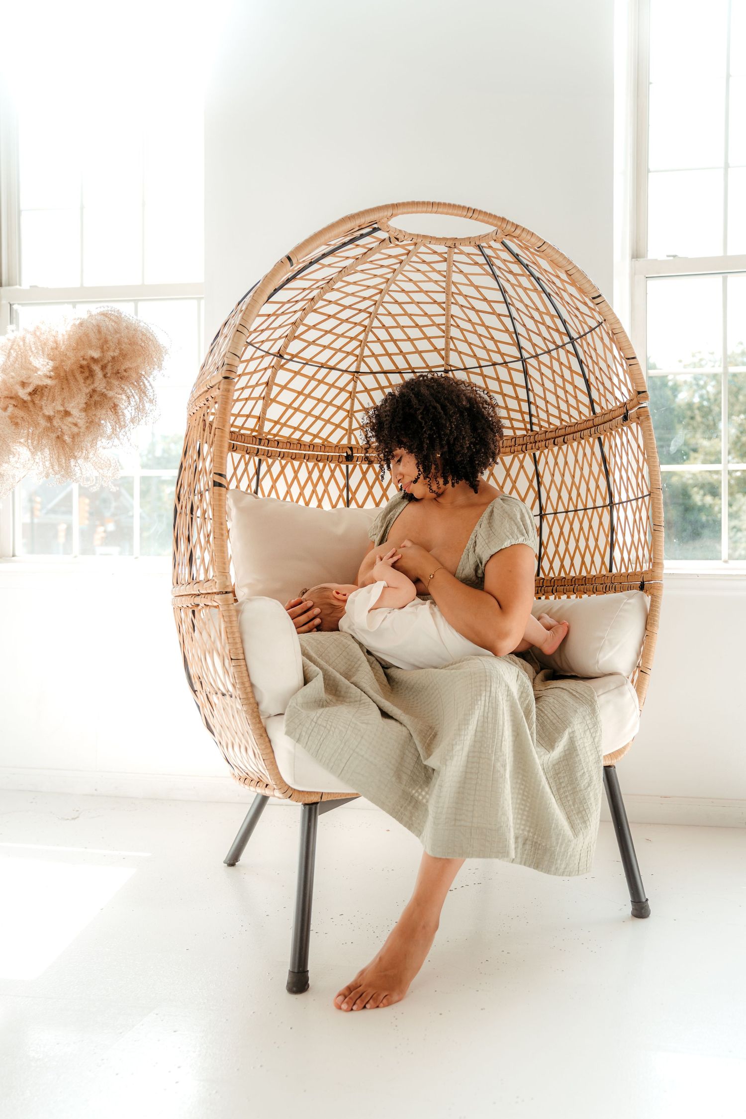 Mom breastfeeding son during an indoor studio family session in Charlotte, NC.