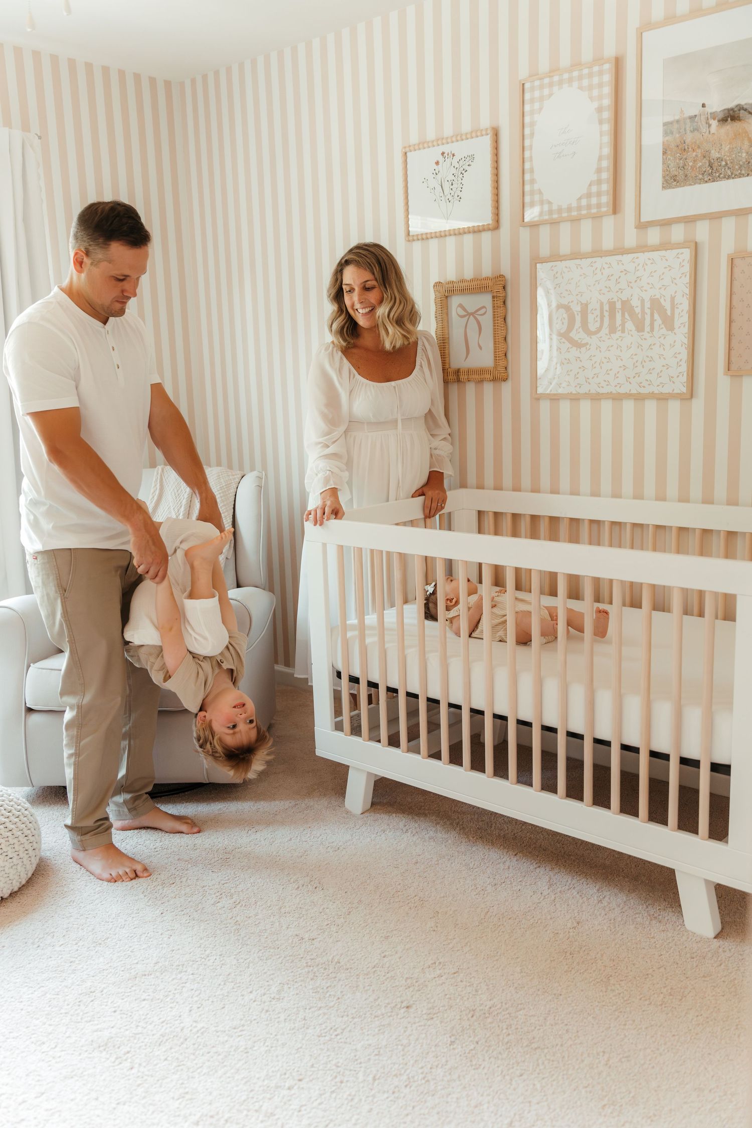 Family of four playing in a sunlit nursery during an in-home family lifestyle session in Fort Mill, SC.