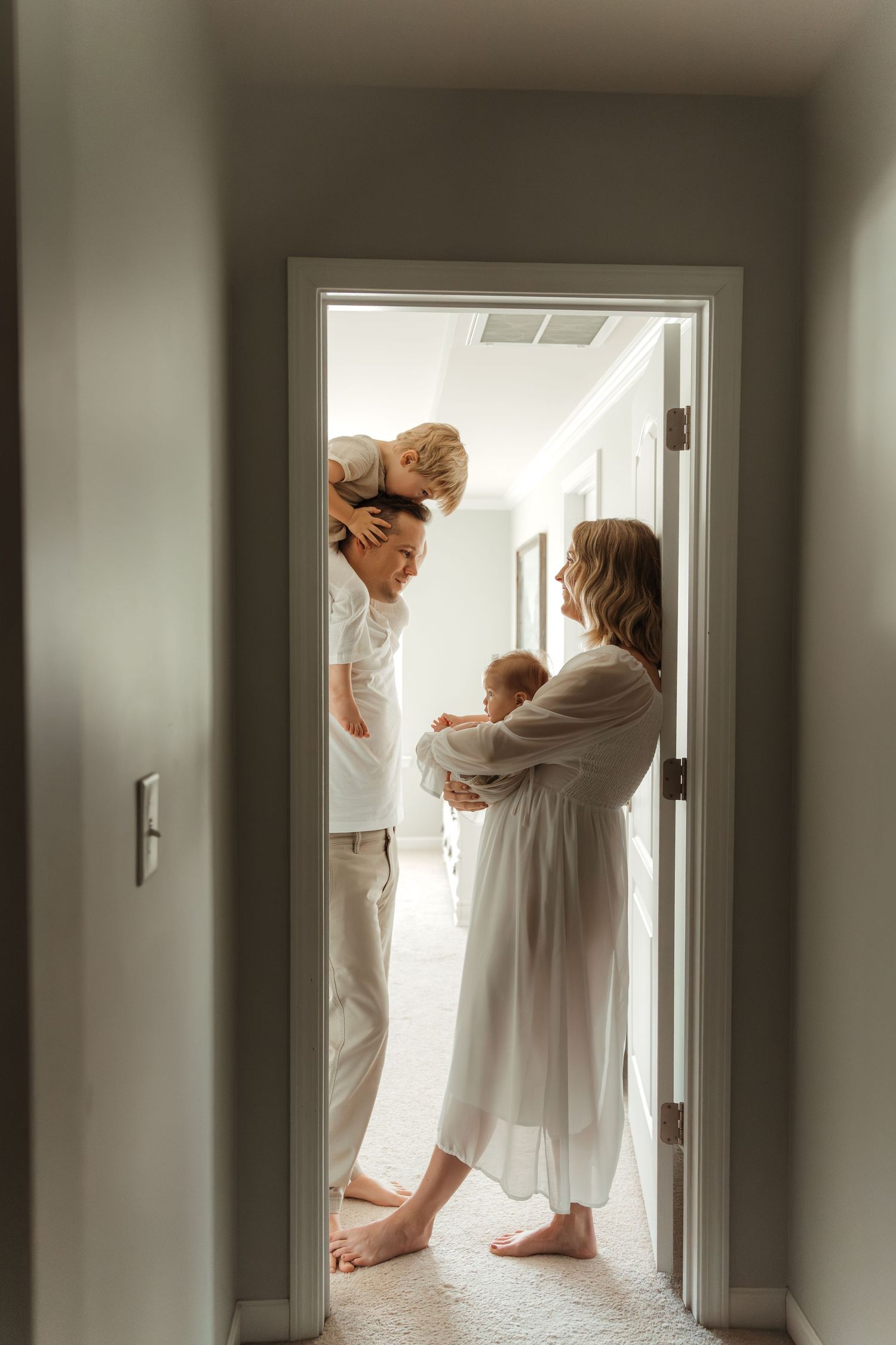 Family of four standing in a doorway during an in-home family lifestyle session in Fort Mill, SC.