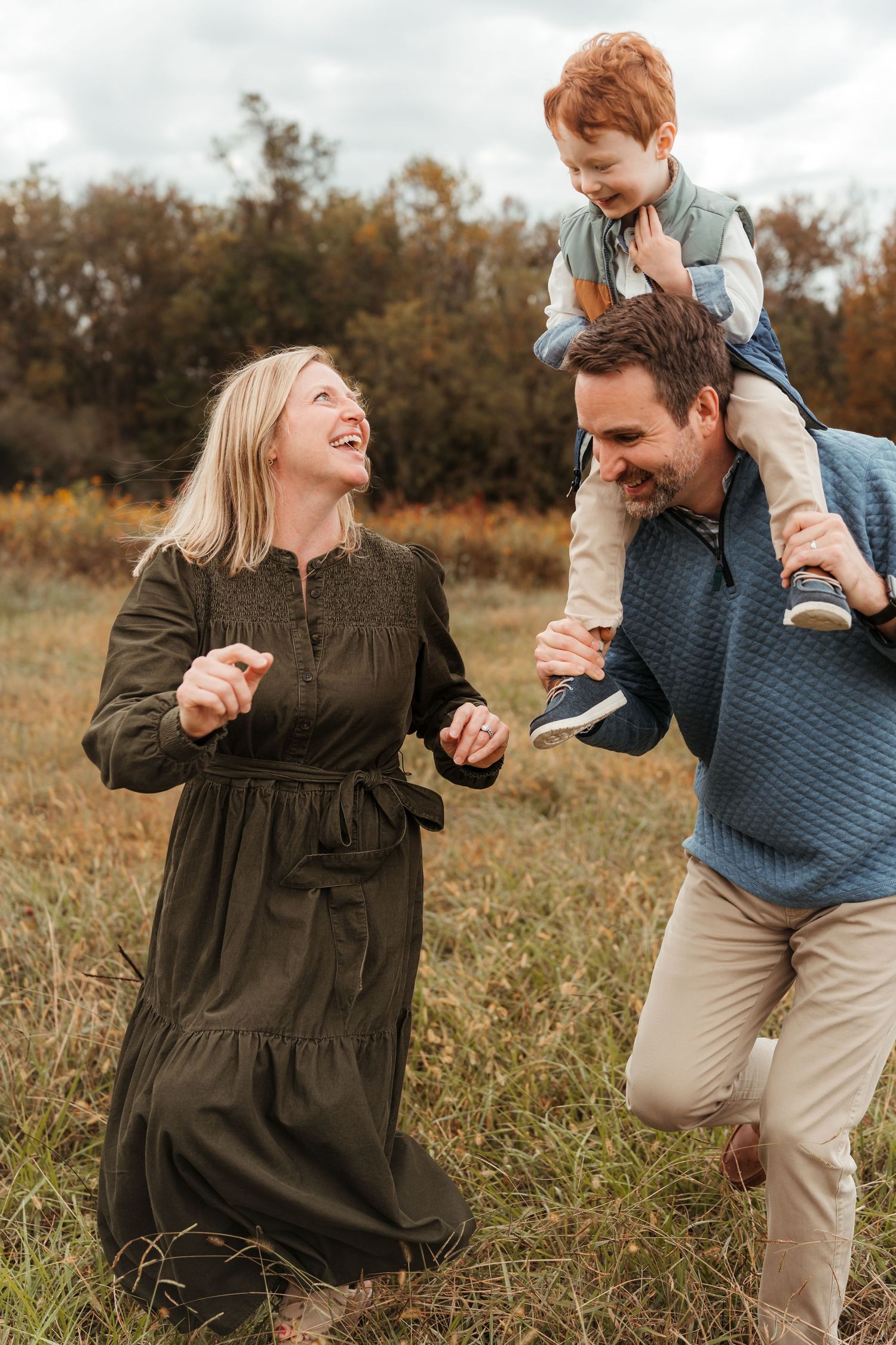 Family of three playing tag during this lifestyle family session at Five Blossoms Farm located in Clover, SC