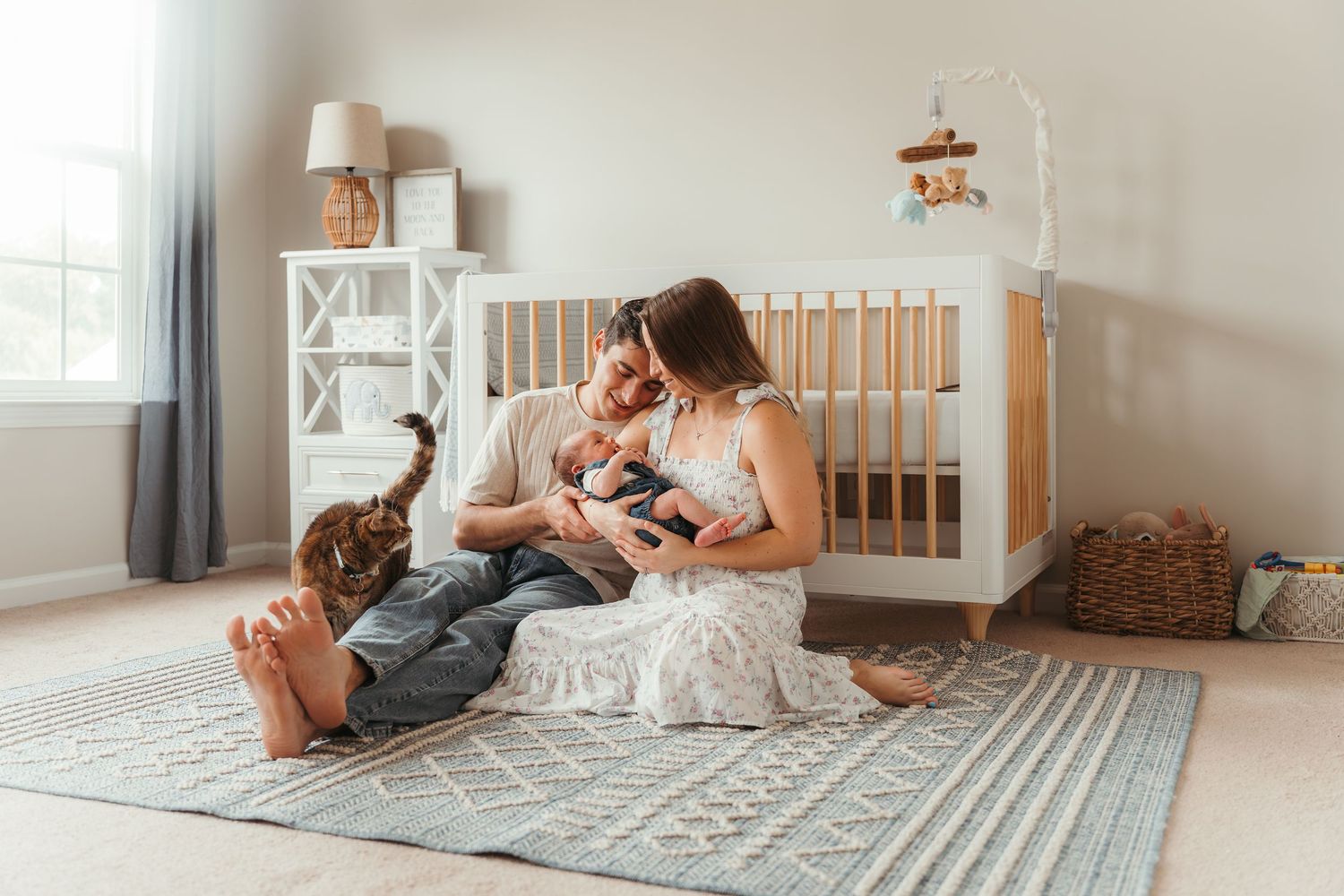 Parents gently cradling newborn during a lifestyle newborn session in Charlotte, NC.