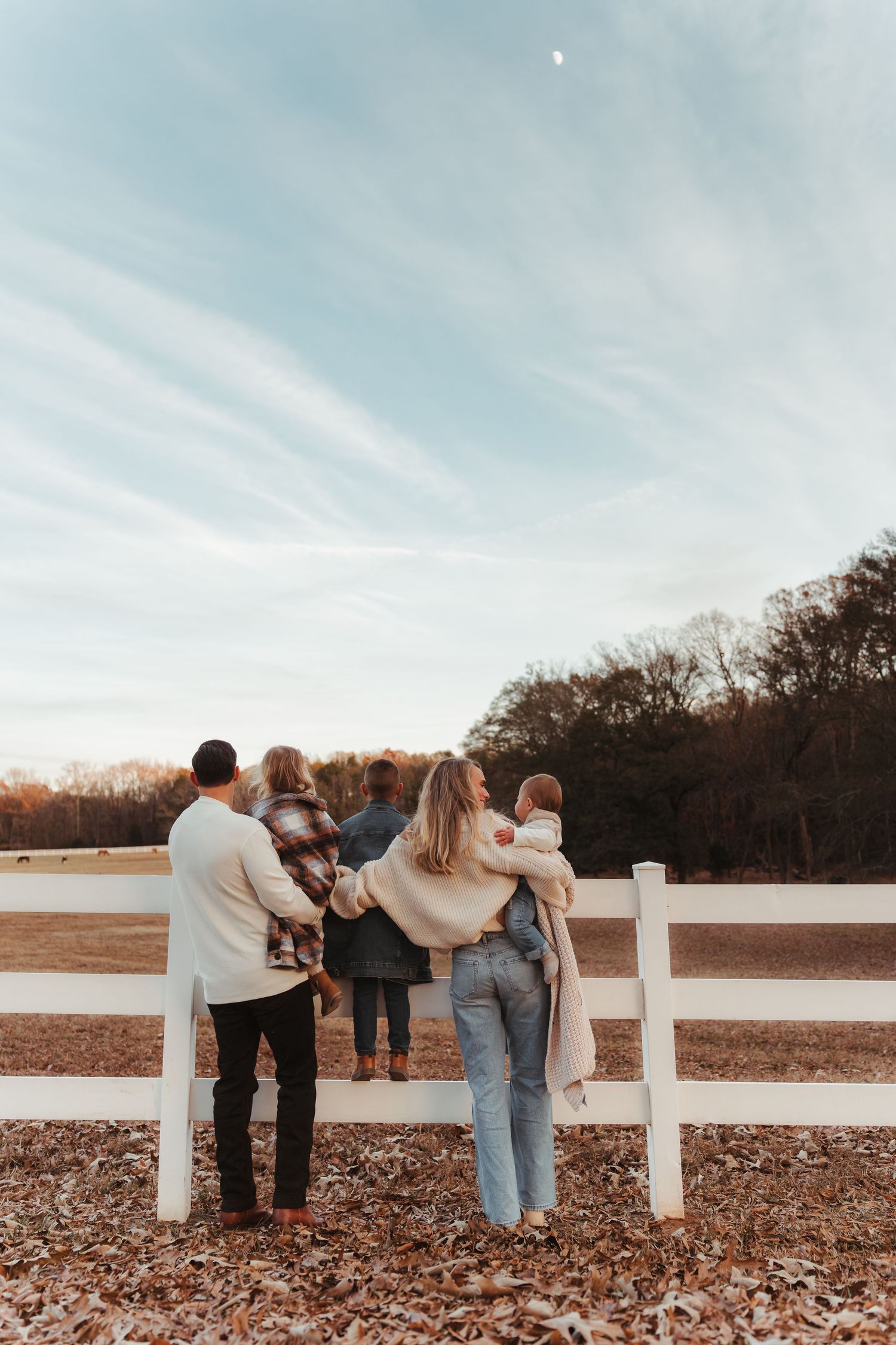 Family of four gazing up at the moon during this natural lifestyle family photography session in Fort Mill, SC.